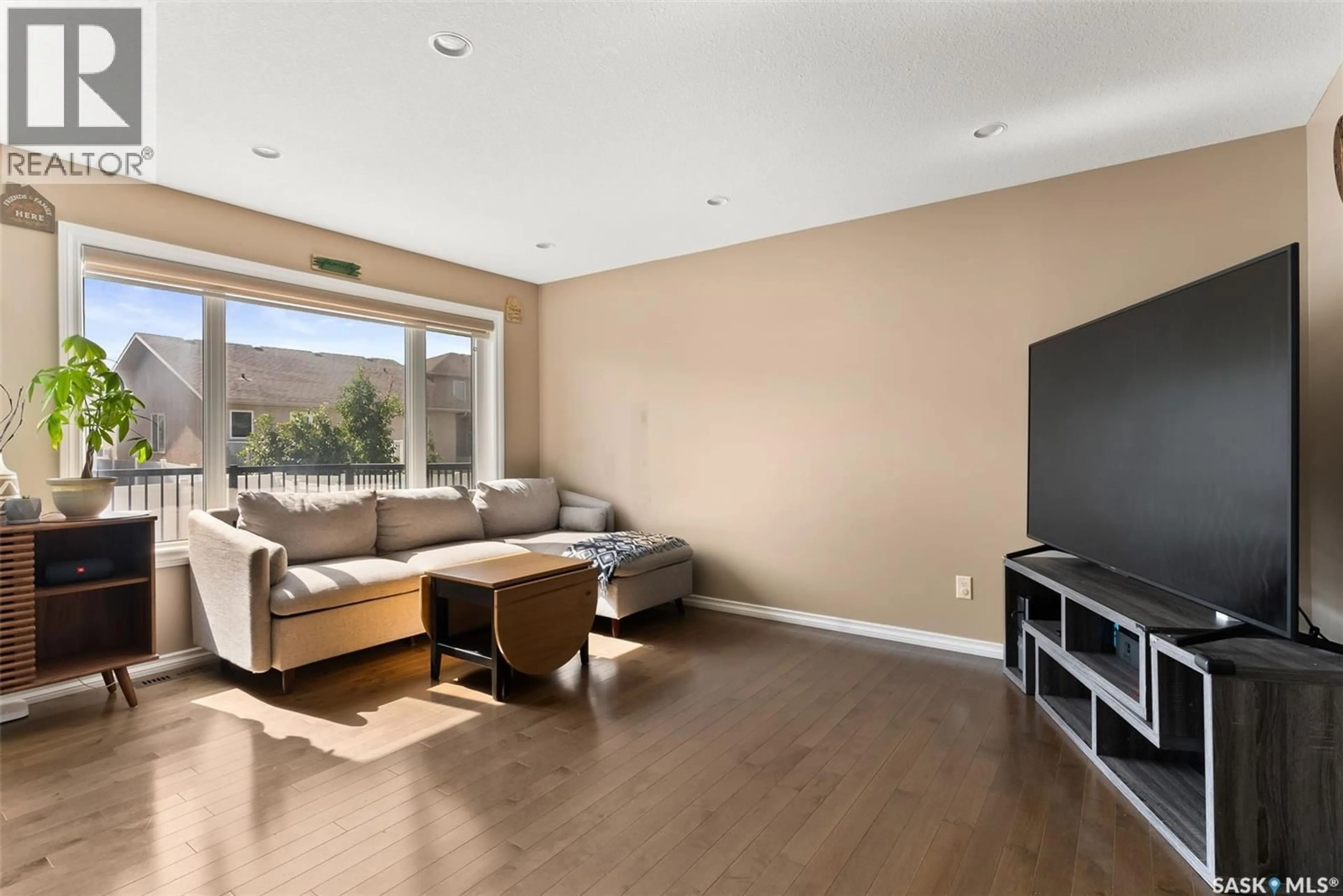 Living room with furniture, wood/laminate floor for 4313 MCMILLAN DRIVE, Regina Saskatchewan S4X0C6