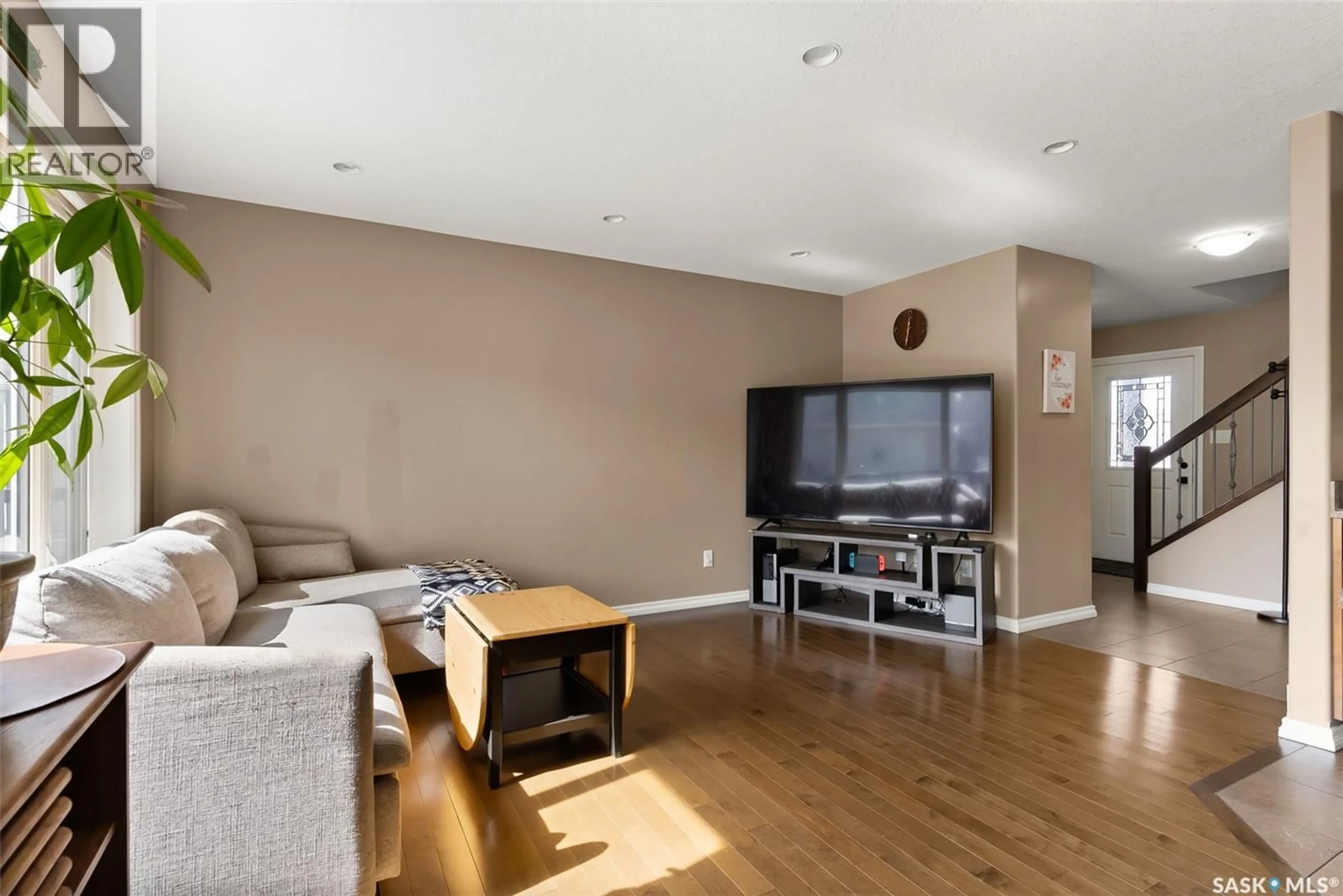 Living room with furniture, wood/laminate floor for 4313 MCMILLAN DRIVE, Regina Saskatchewan S4X0C6