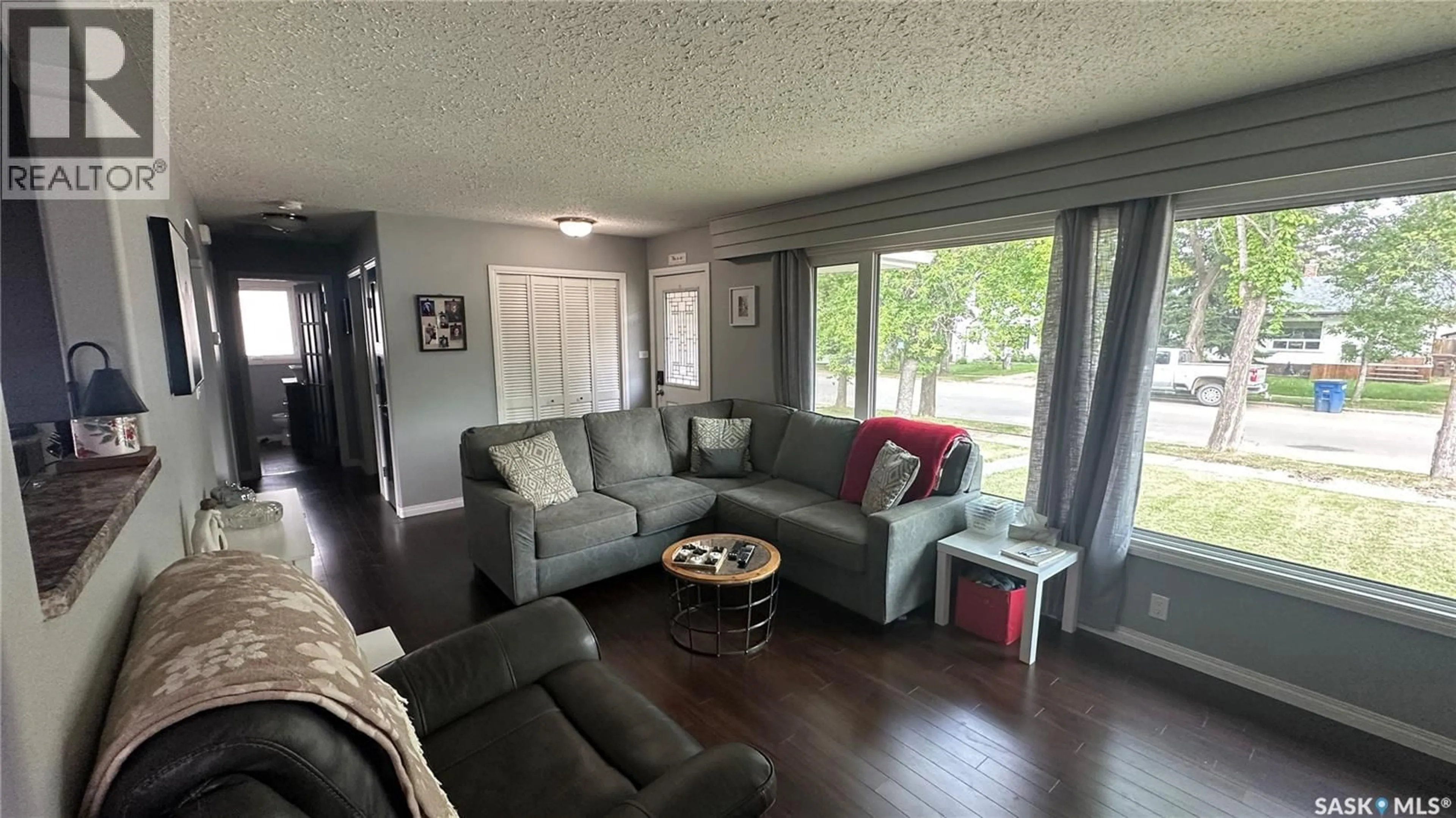 Living room with furniture, wood/laminate floor for 1010 105TH AVENUE, Tisdale Saskatchewan S0E1T0
