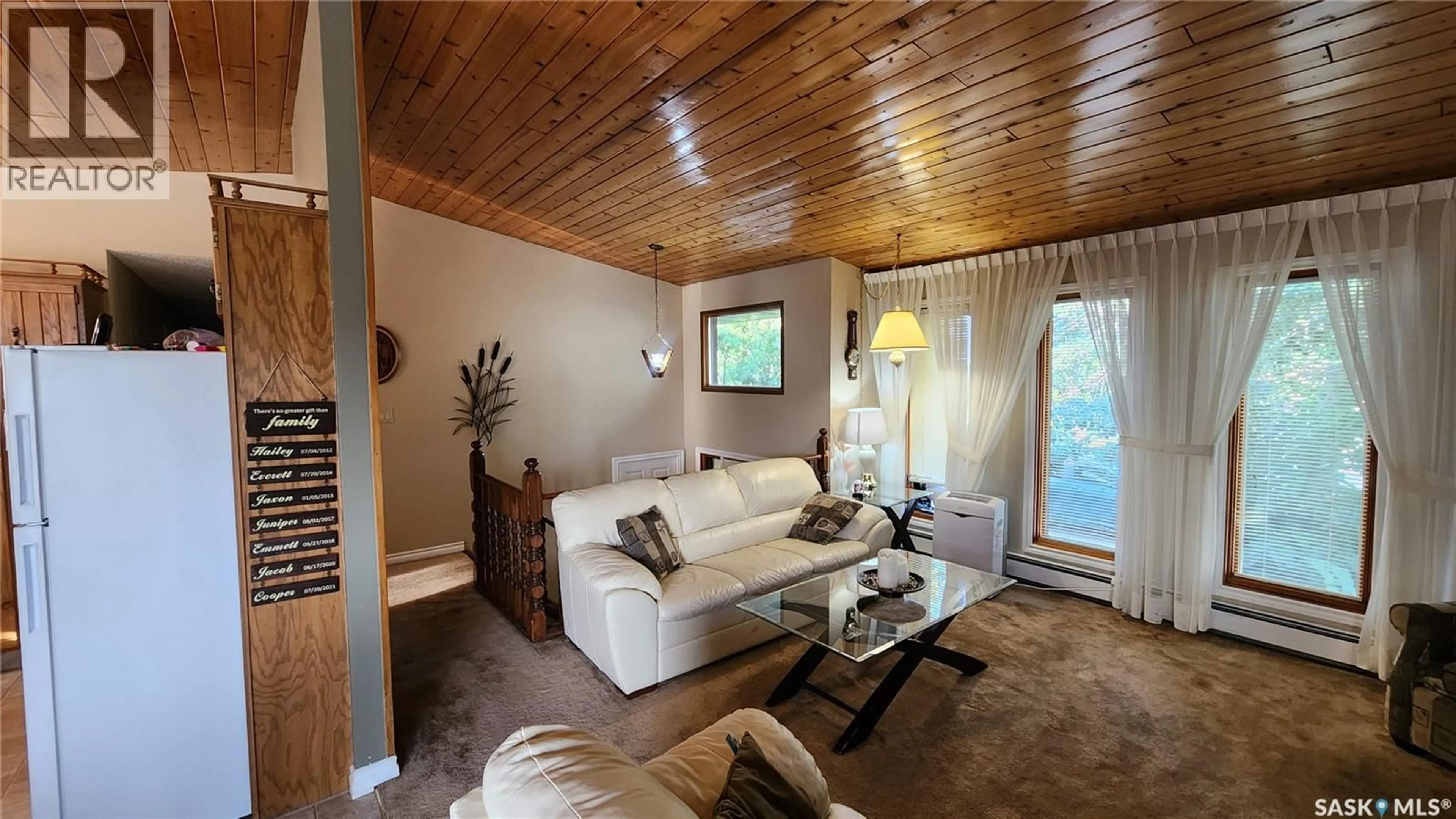 Living room with furniture, wood/laminate floor for 91 18TH STREET, Battleford Saskatchewan S0M0E0