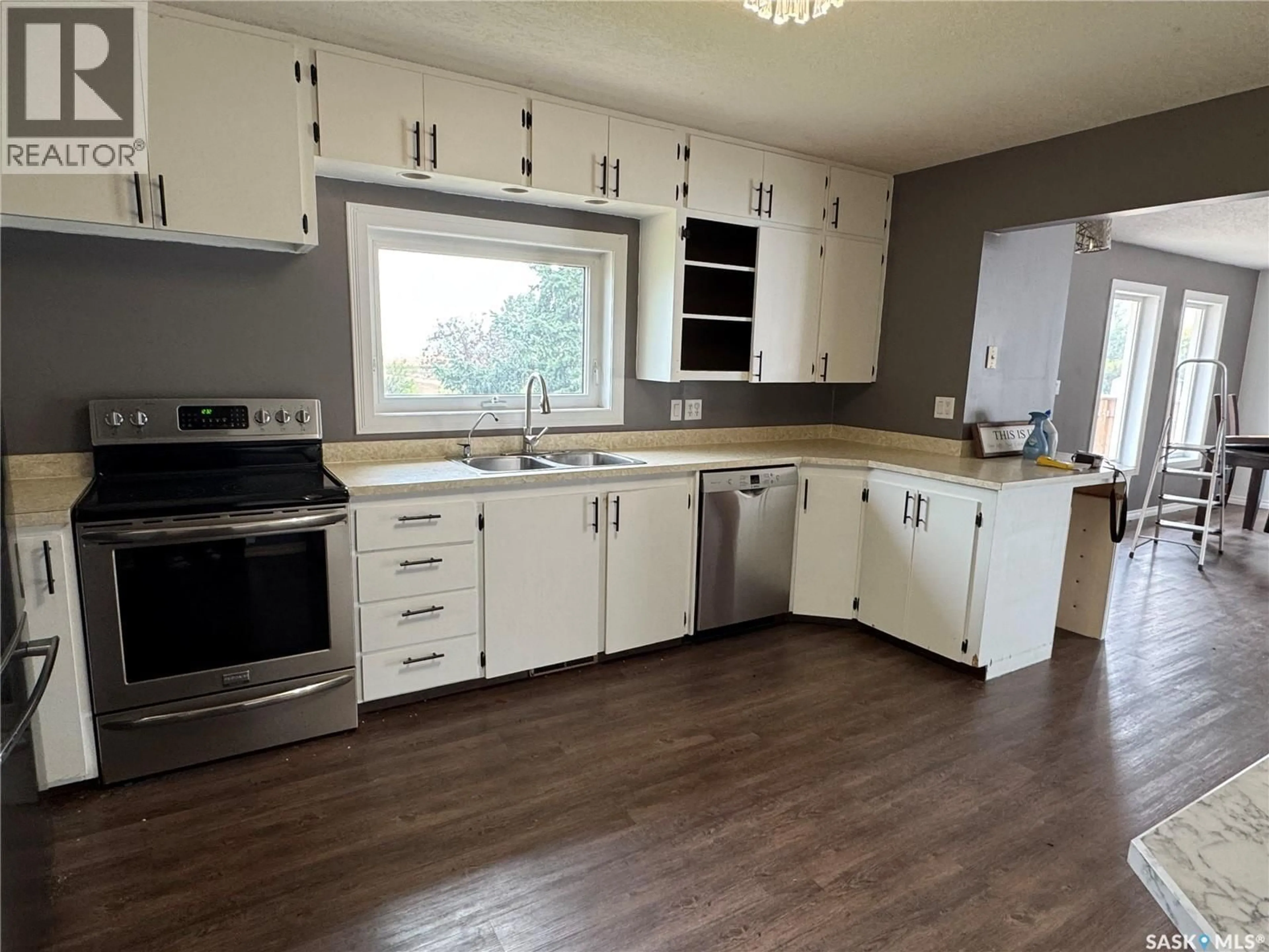 Open concept kitchen, wood/laminate floor for WILLER ACREAGE, Stonehenge Rm No. 73 Saskatchewan S0H0B0