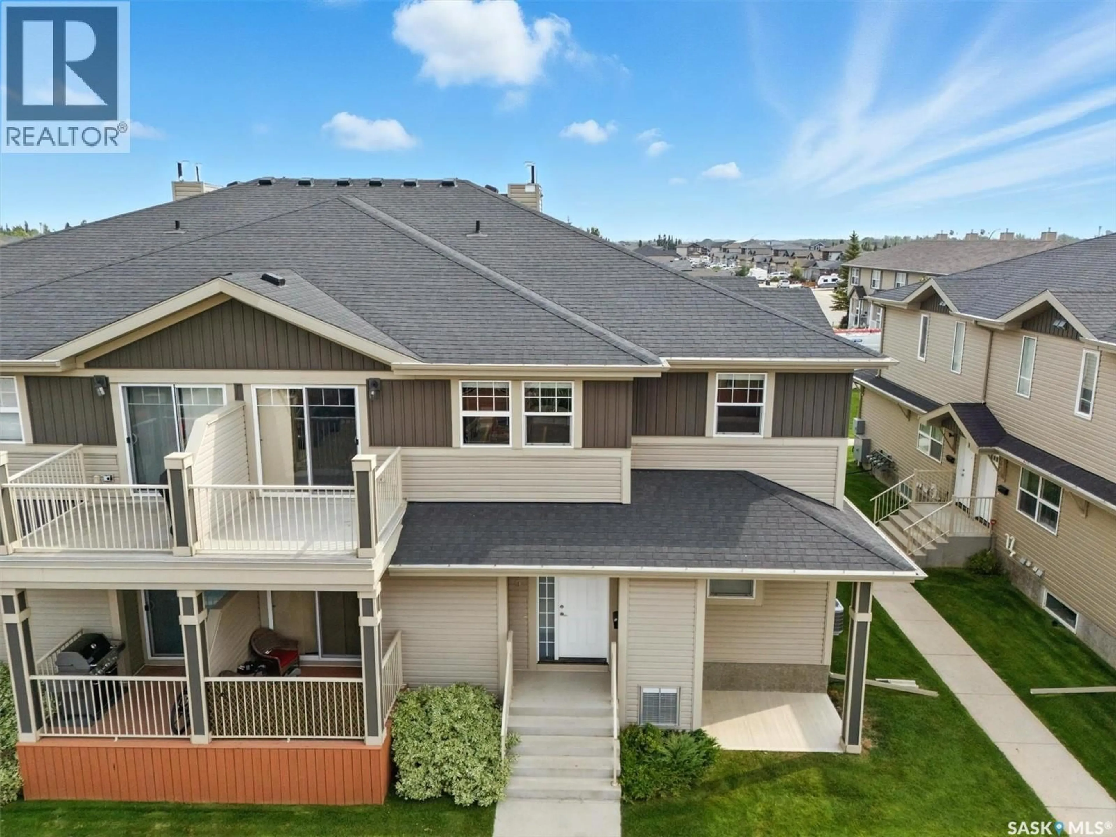 A pic from outside/outdoor area/front of a property/back of a property/a pic from drone, mountain view for 100 - 213 CHAPARRAL BOULEVARD, Martensville Saskatchewan S0K0A2