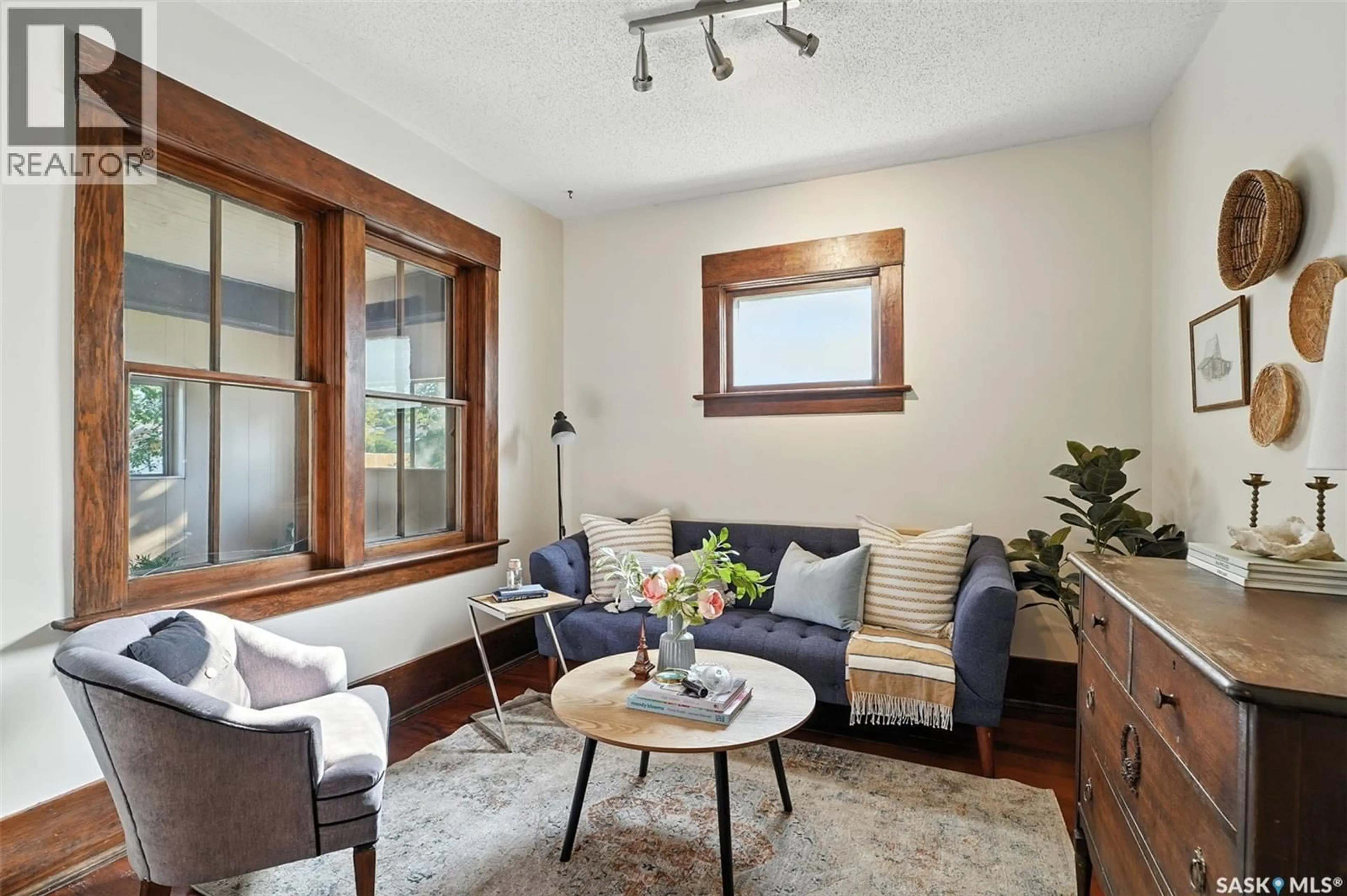 Living room with furniture, wood/laminate floor for 105 115TH STREET, Saskatoon Saskatchewan S7N2E1
