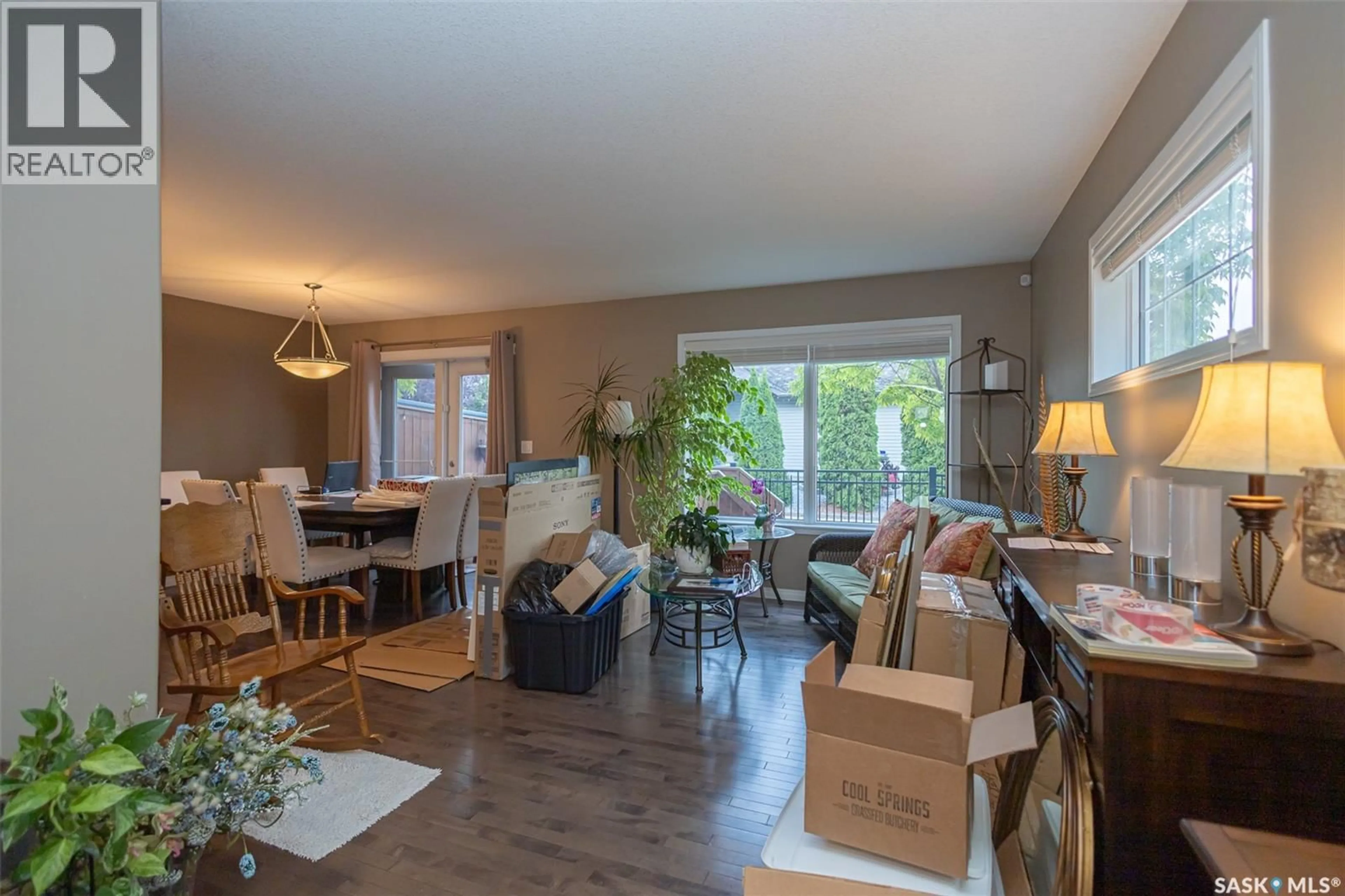 Living room with furniture, wood/laminate floor for 110 - 6 DULMAGE CRESCENT, Saskatoon Saskatchewan S7T0C7