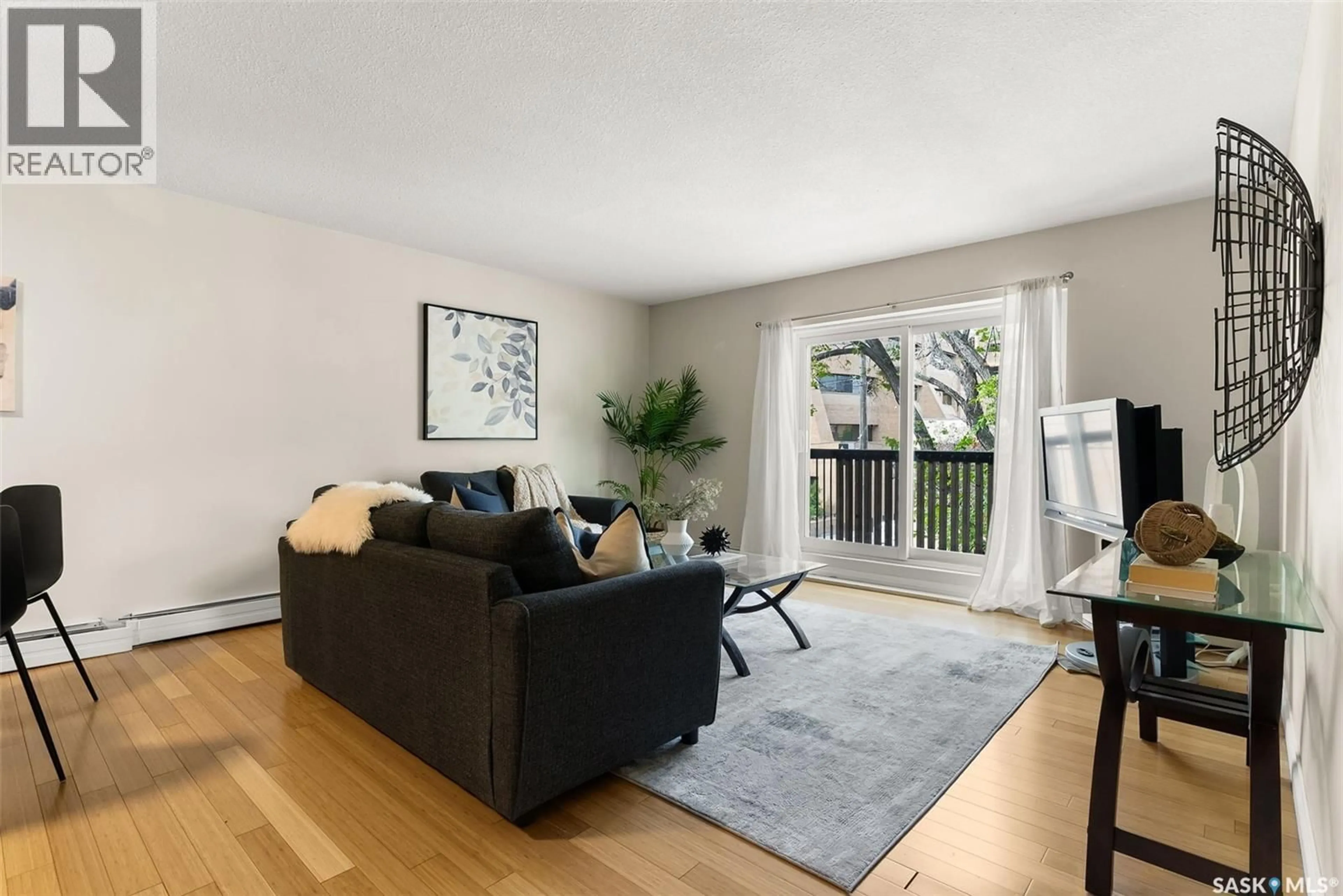 Living room with furniture, wood/laminate floor for 2104 - 9 MCINTYRE STREET, Regina Saskatchewan S4P2R7