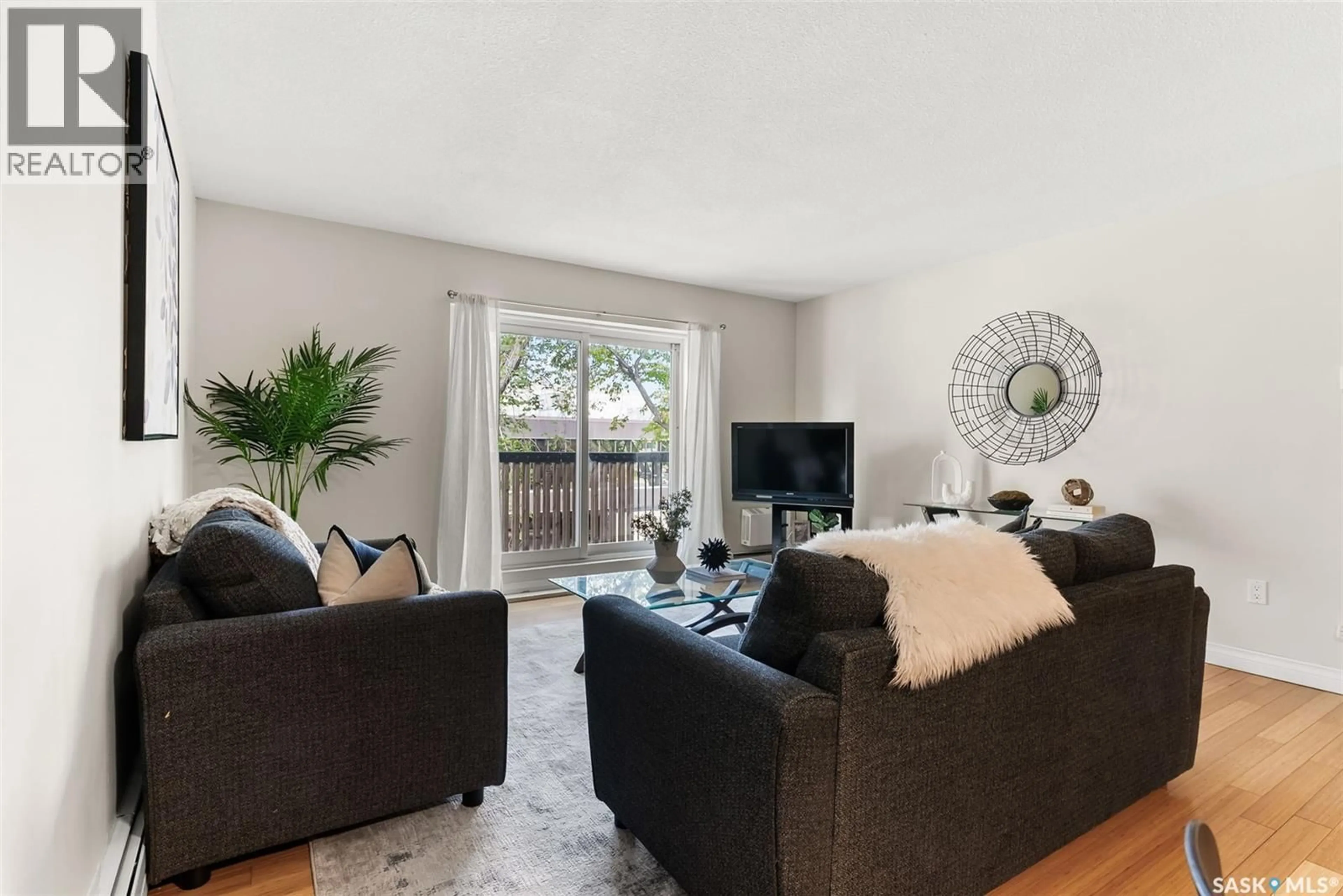 Living room with furniture, wood/laminate floor for 2104 - 9 MCINTYRE STREET, Regina Saskatchewan S4P2R7