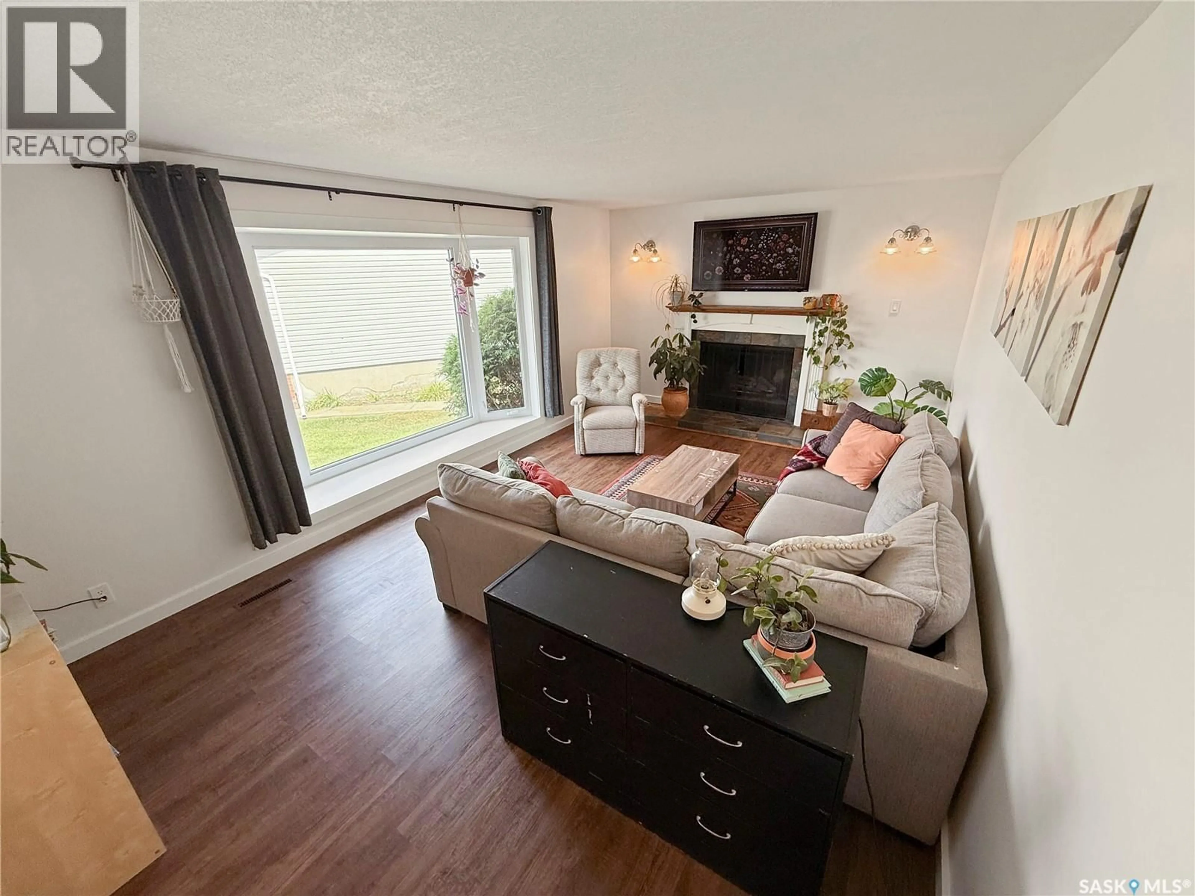 Living room with furniture, wood/laminate floor for 32 WEST PLACE, Swift Current Saskatchewan S9H4C7