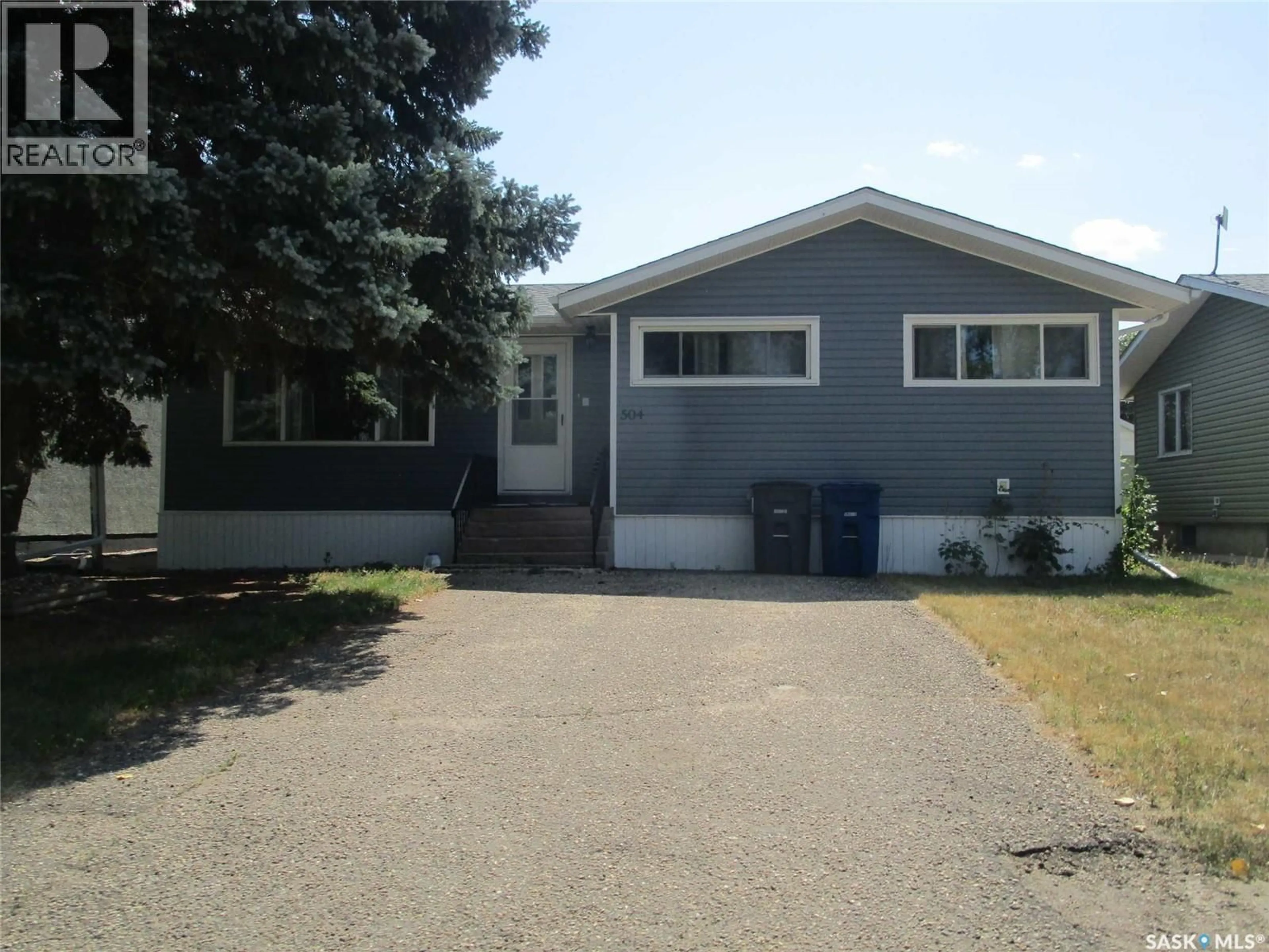 Home with vinyl exterior material, street for 504 4TH AVENUE, Assiniboia Saskatchewan S0H0B0