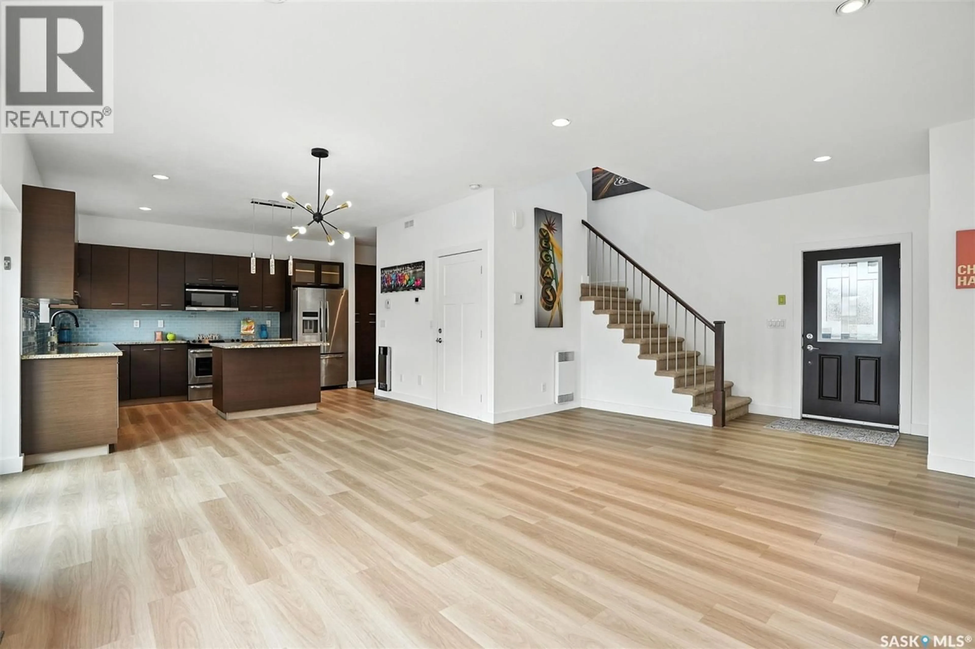 Open concept kitchen, wood/laminate floor for 122 ROY CRESCENT, Saskatoon Saskatchewan S7W0K9