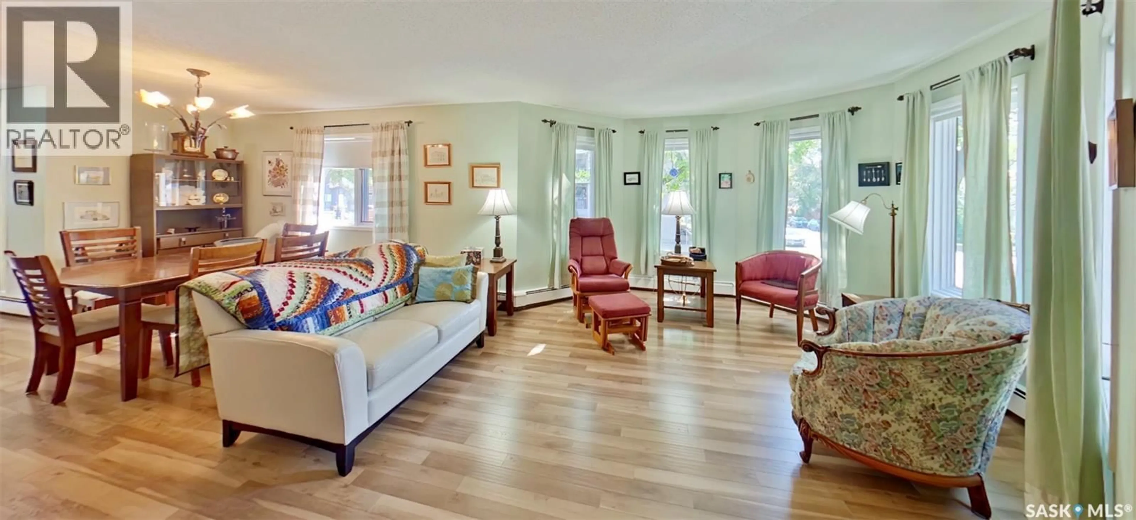 Living room with furniture, wood/laminate floor for 204 - 2275 MCINTYRE STREET, Regina Saskatchewan S4P2S1
