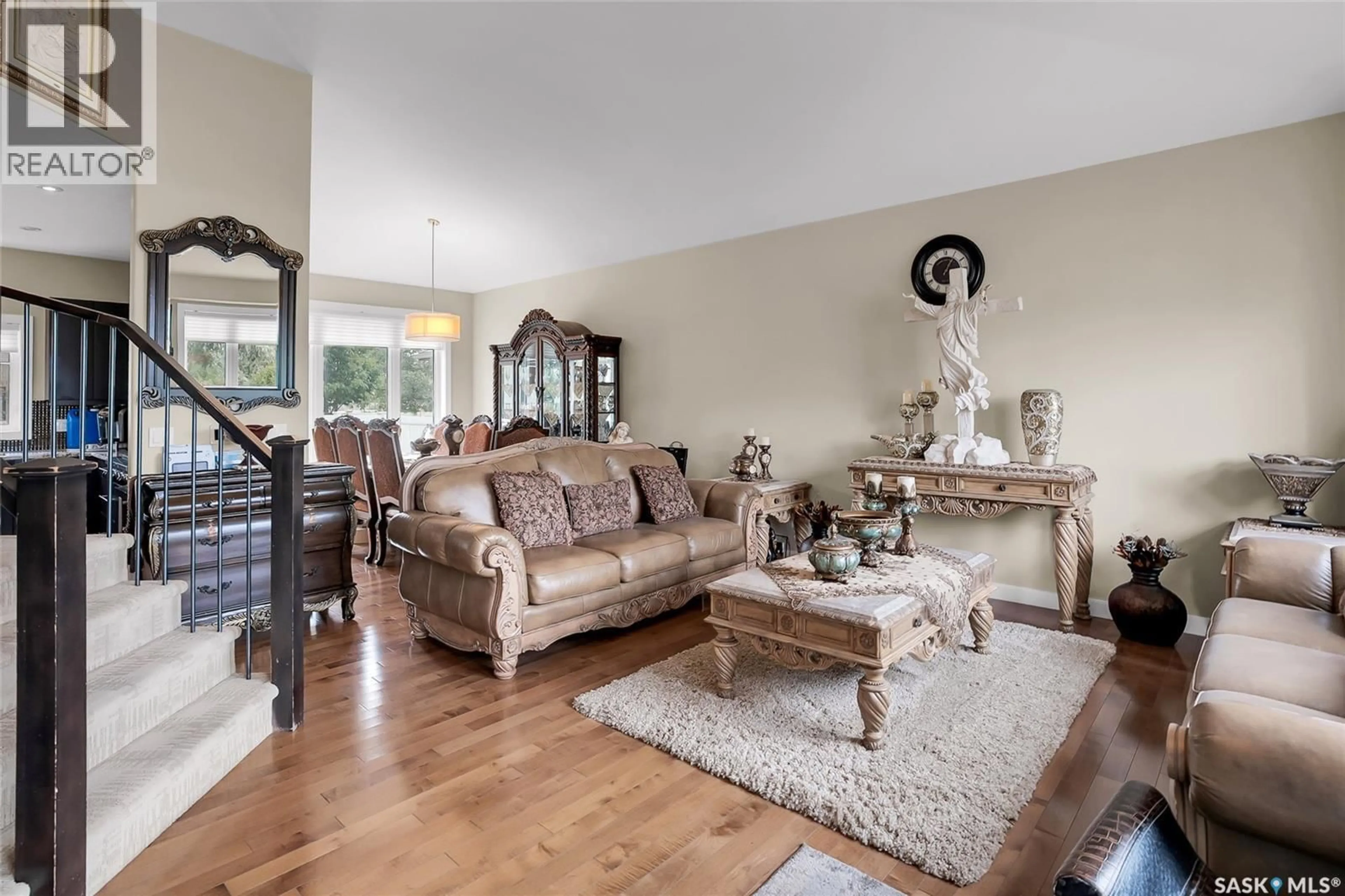 Living room with furniture, wood/laminate floor for 215 BEECHWOOD CRESCENT, Saskatoon Saskatchewan S7V1K6