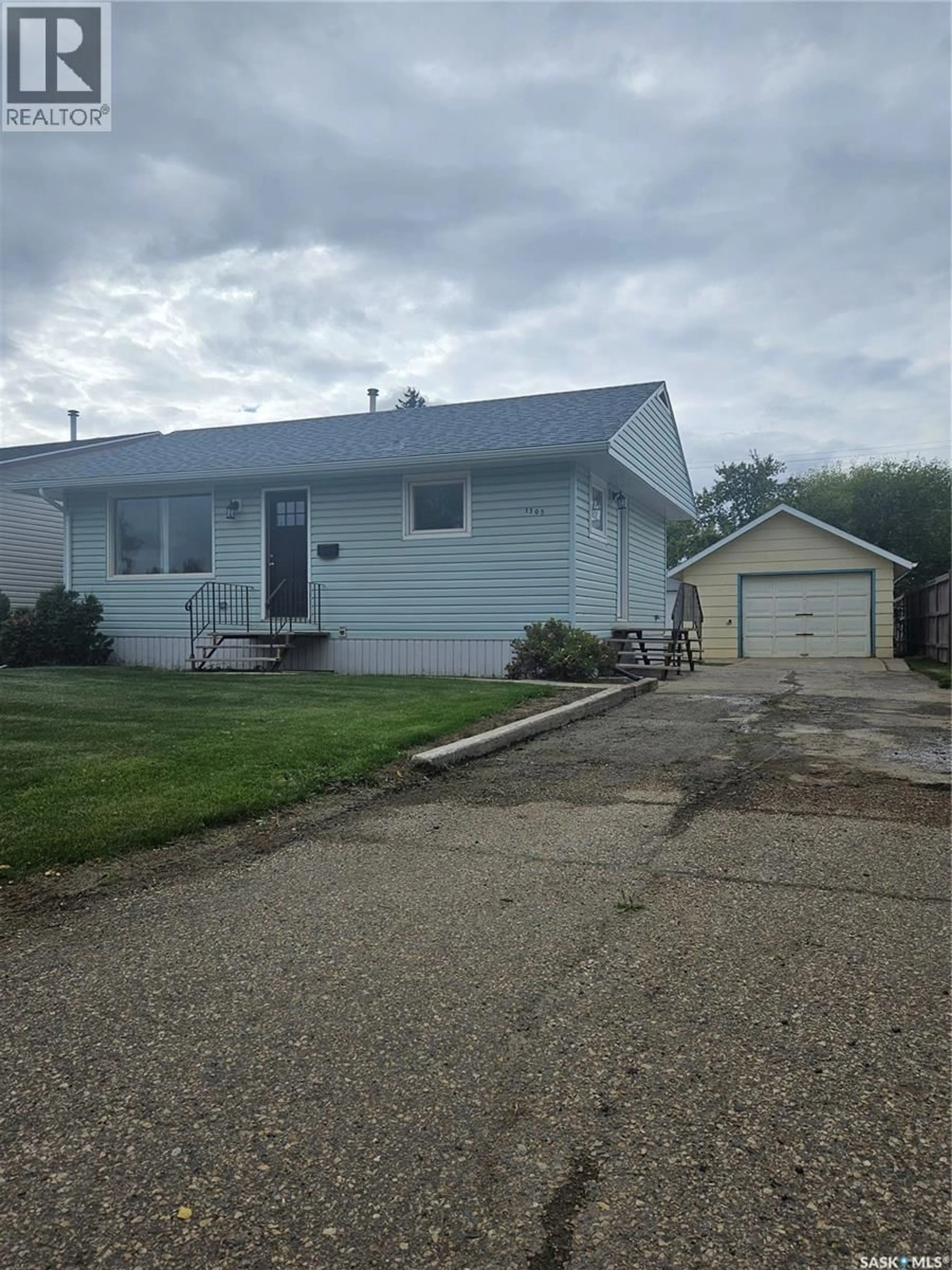Home with vinyl exterior material, street for 1305 96TH STREET, Tisdale Saskatchewan S0E1T0