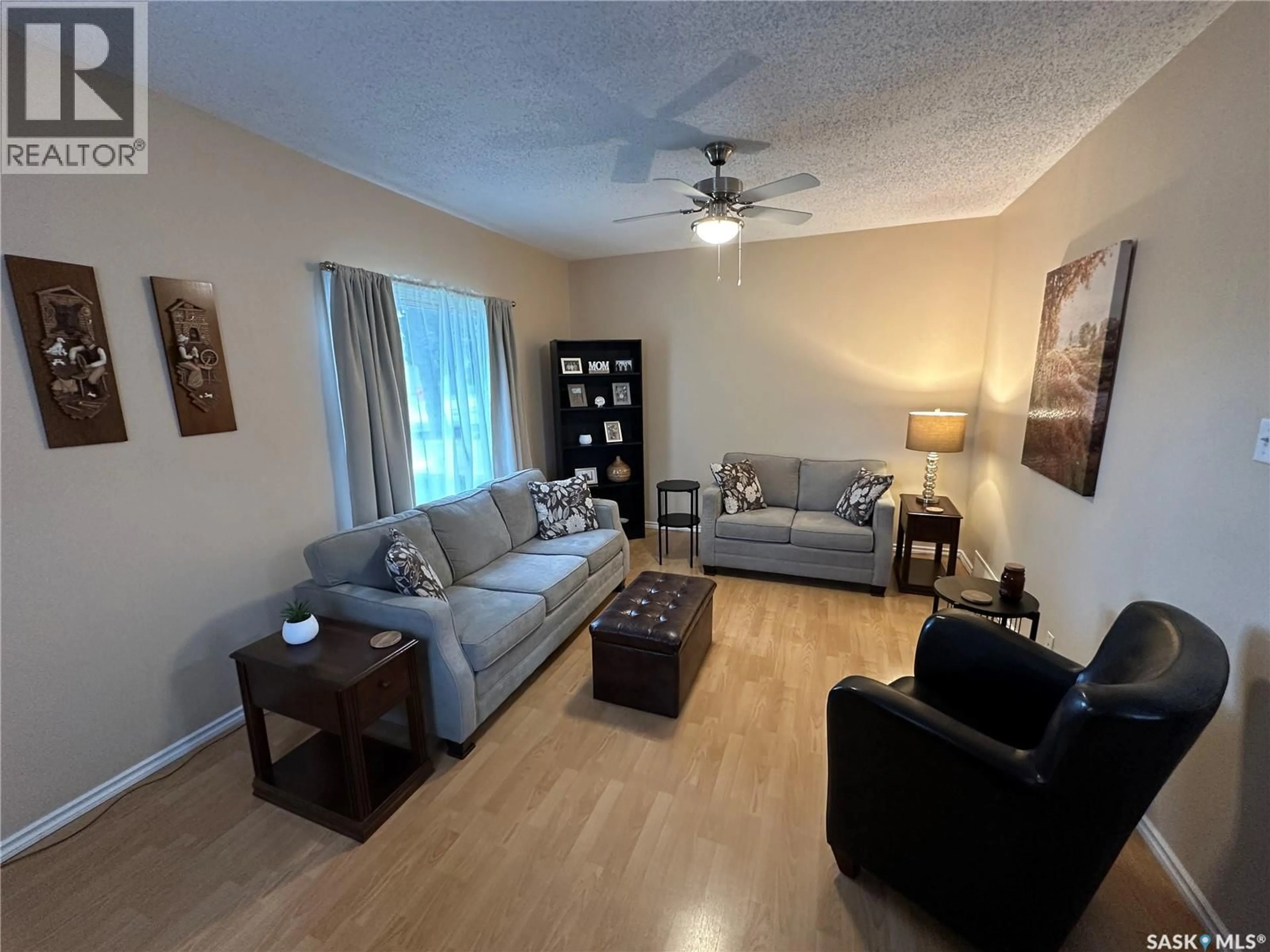 Living room with furniture, wood/laminate floor for 2002 3RD STREET, Rosthern Saskatchewan S0K3R0
