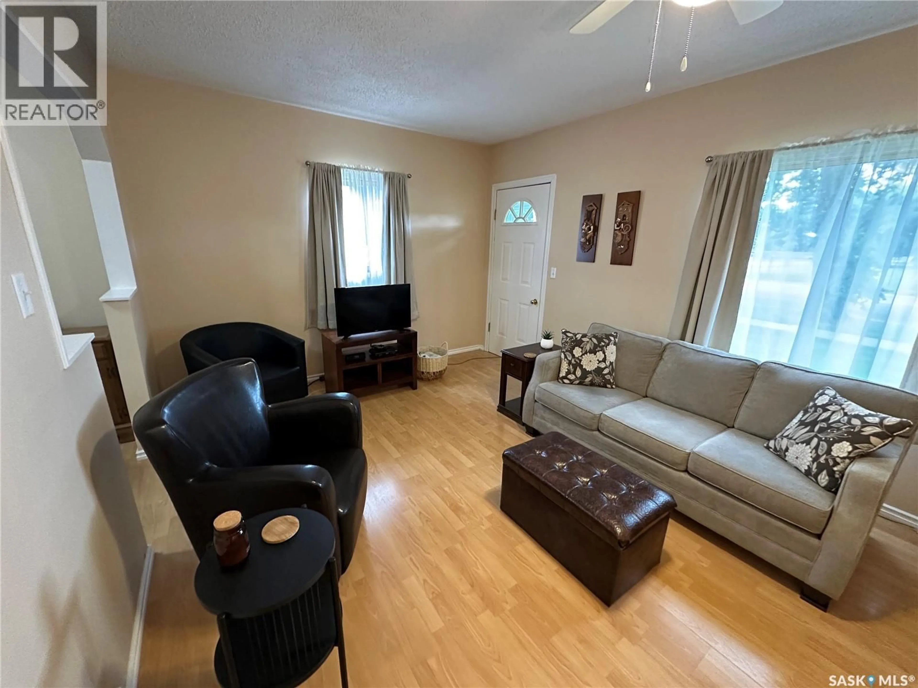 Living room with furniture, wood/laminate floor for 2002 3RD STREET, Rosthern Saskatchewan S0K3R0