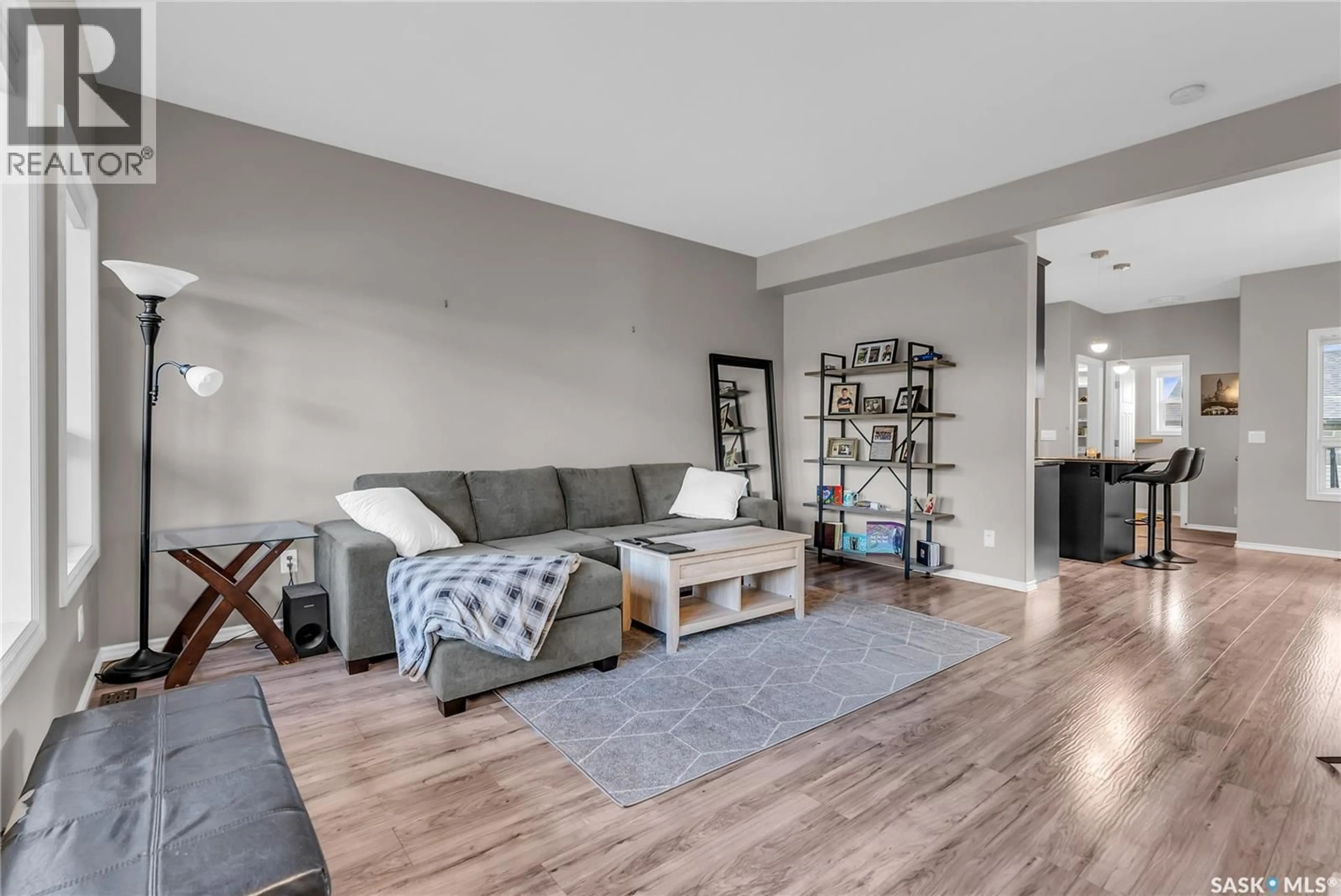 Living room with furniture, wood/laminate floor for 343 WILLOWGROVE LANE, Saskatoon Saskatchewan S7W0H5