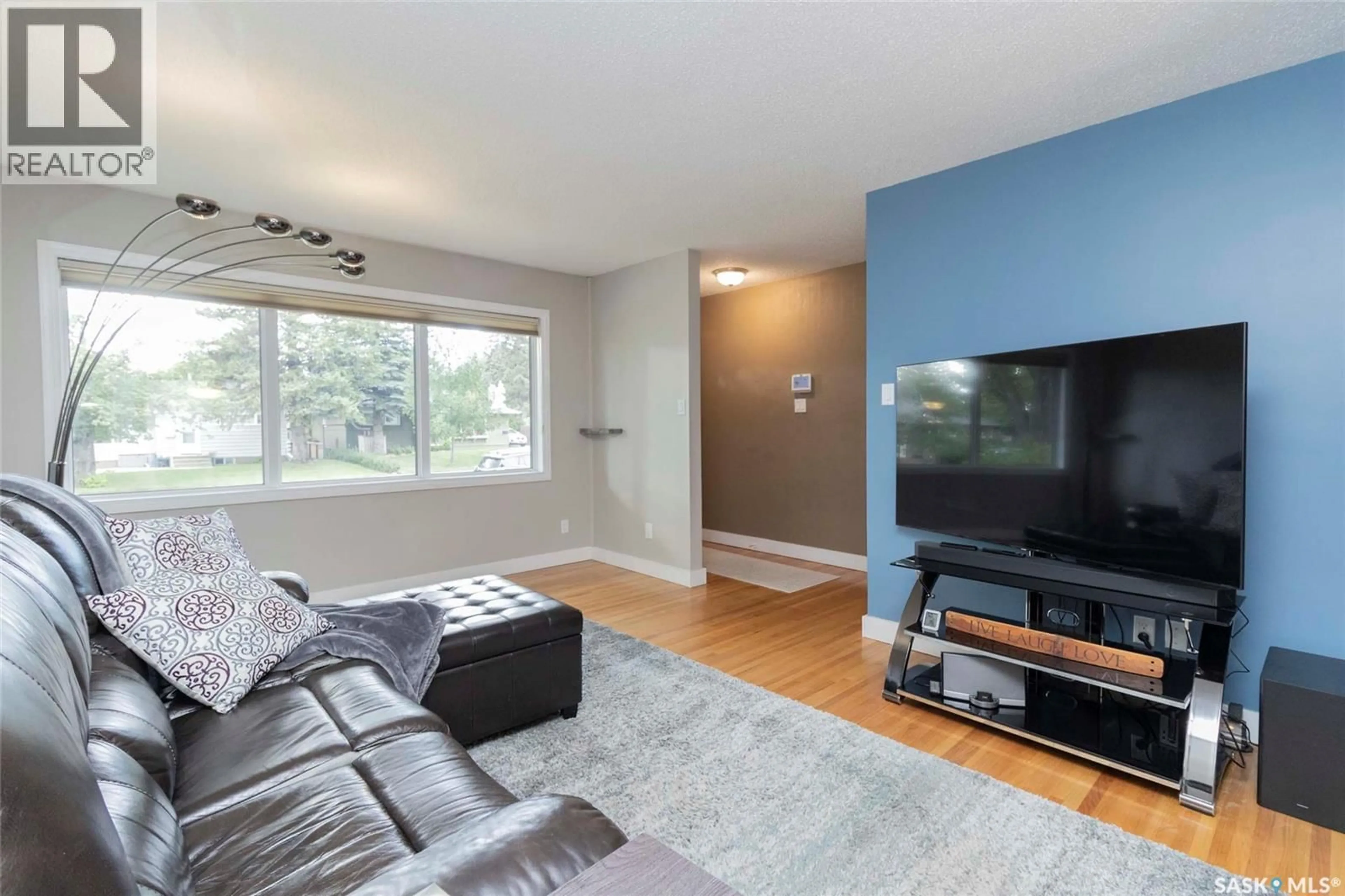 Living room with furniture, wood/laminate floor for 1801 MORGAN AVENUE, Saskatoon Saskatchewan S7H2S2
