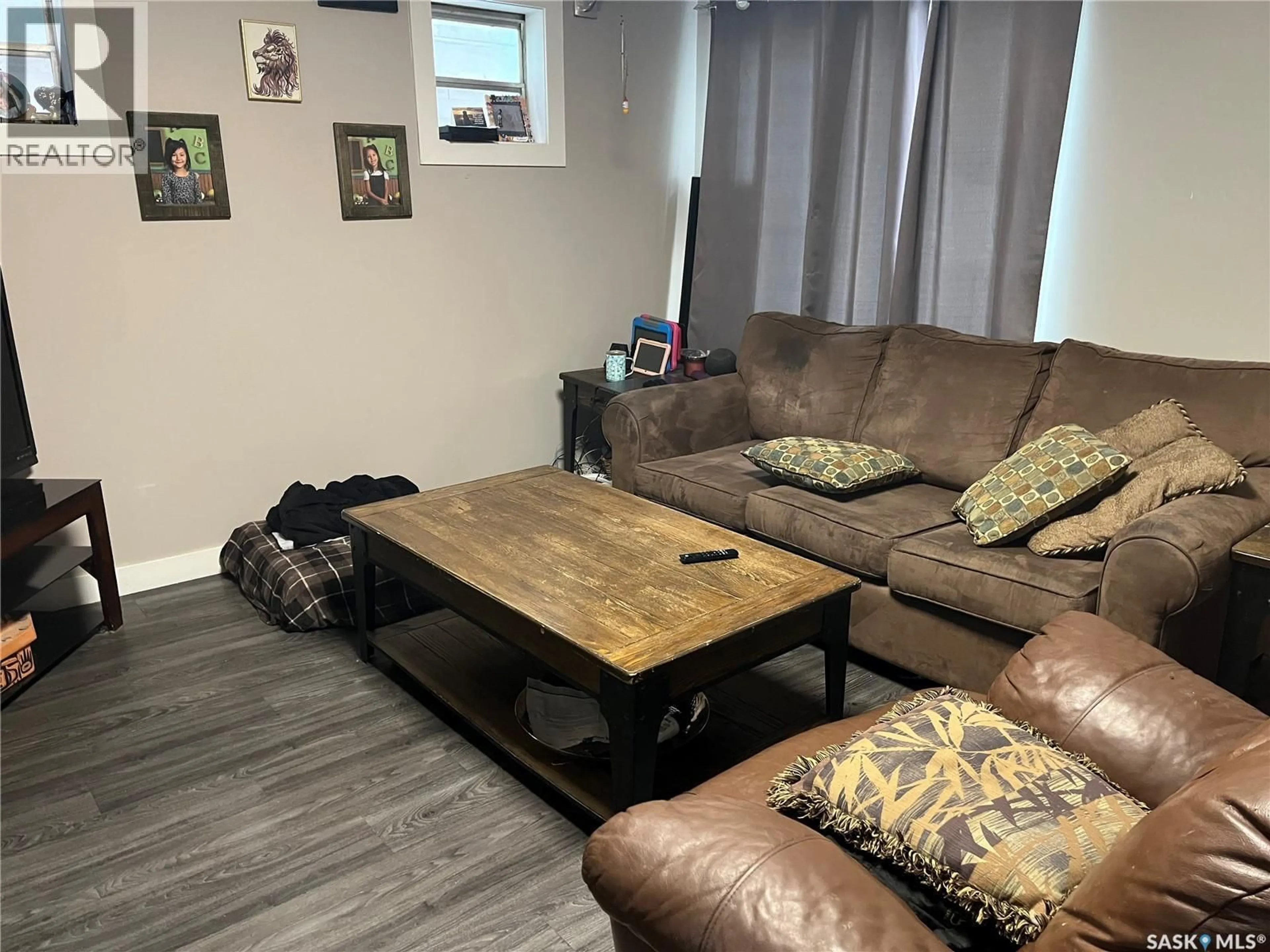 Living room with furniture, wood/laminate floor for 1447 ROBINSON STREET, Regina Saskatchewan S4T2N7