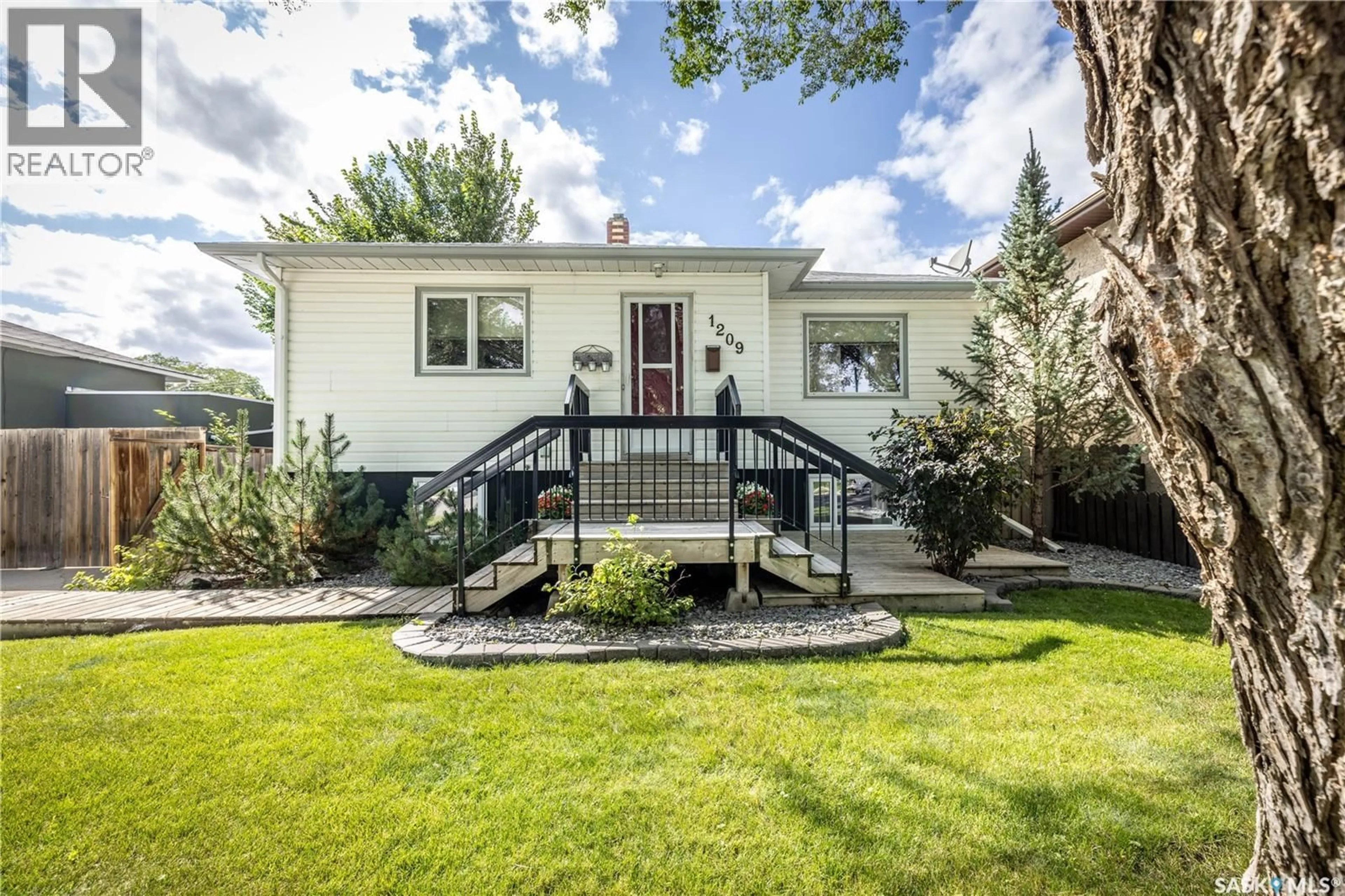 Home with vinyl exterior material, street for 1209 L AVENUE S, Saskatoon Saskatchewan S7M2J9
