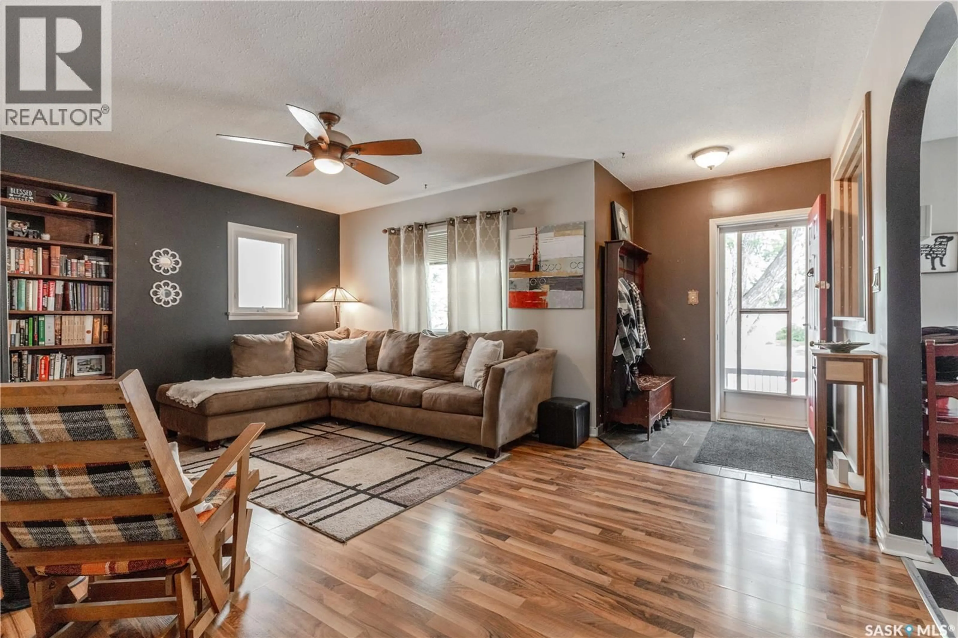 Living room with furniture, wood/laminate floor for 1209 L AVENUE S, Saskatoon Saskatchewan S7M2J9