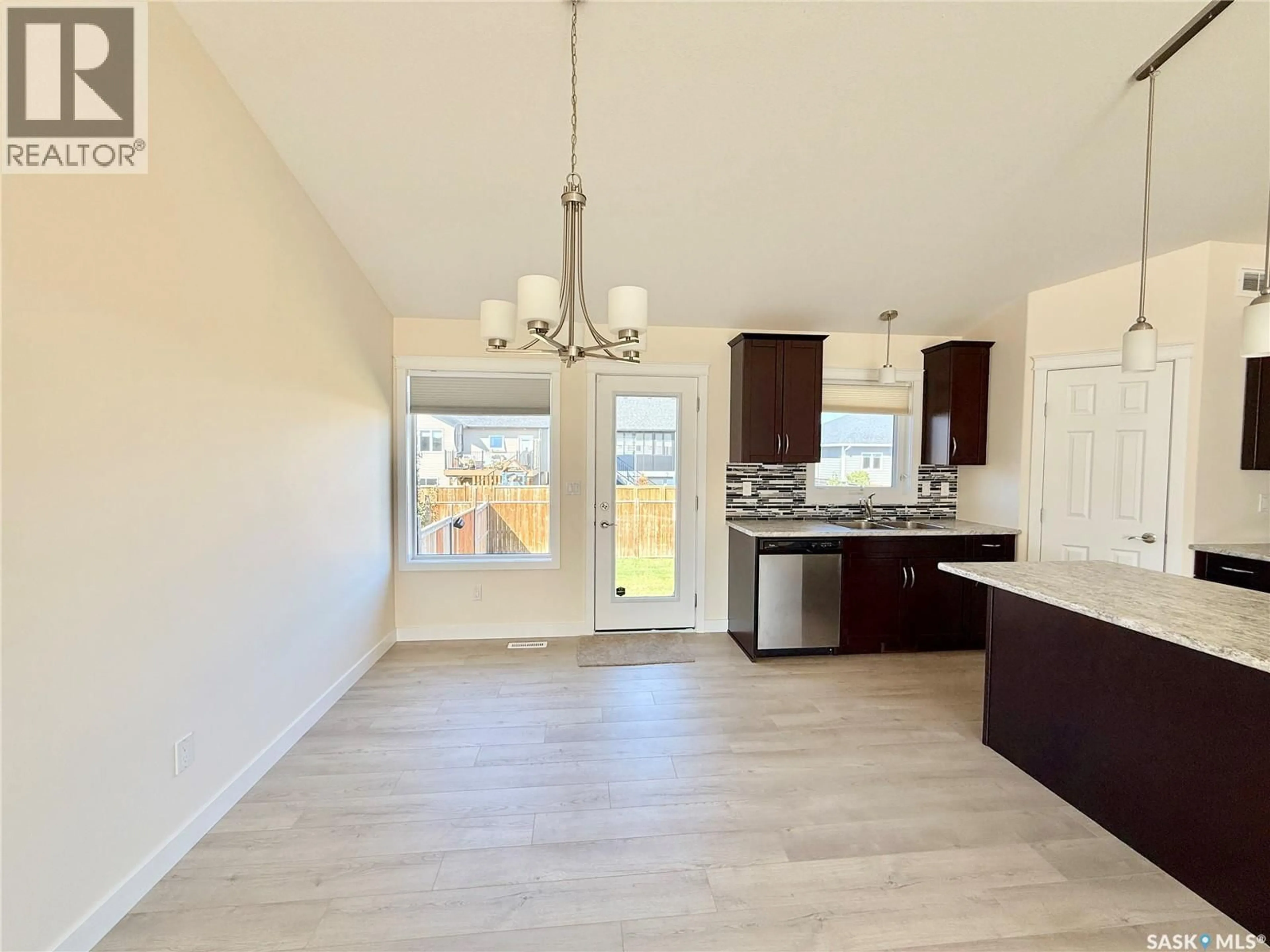 Open concept kitchen, wood/laminate floor for 726 CASPER CRESCENT, Warman Saskatchewan S0K4S4