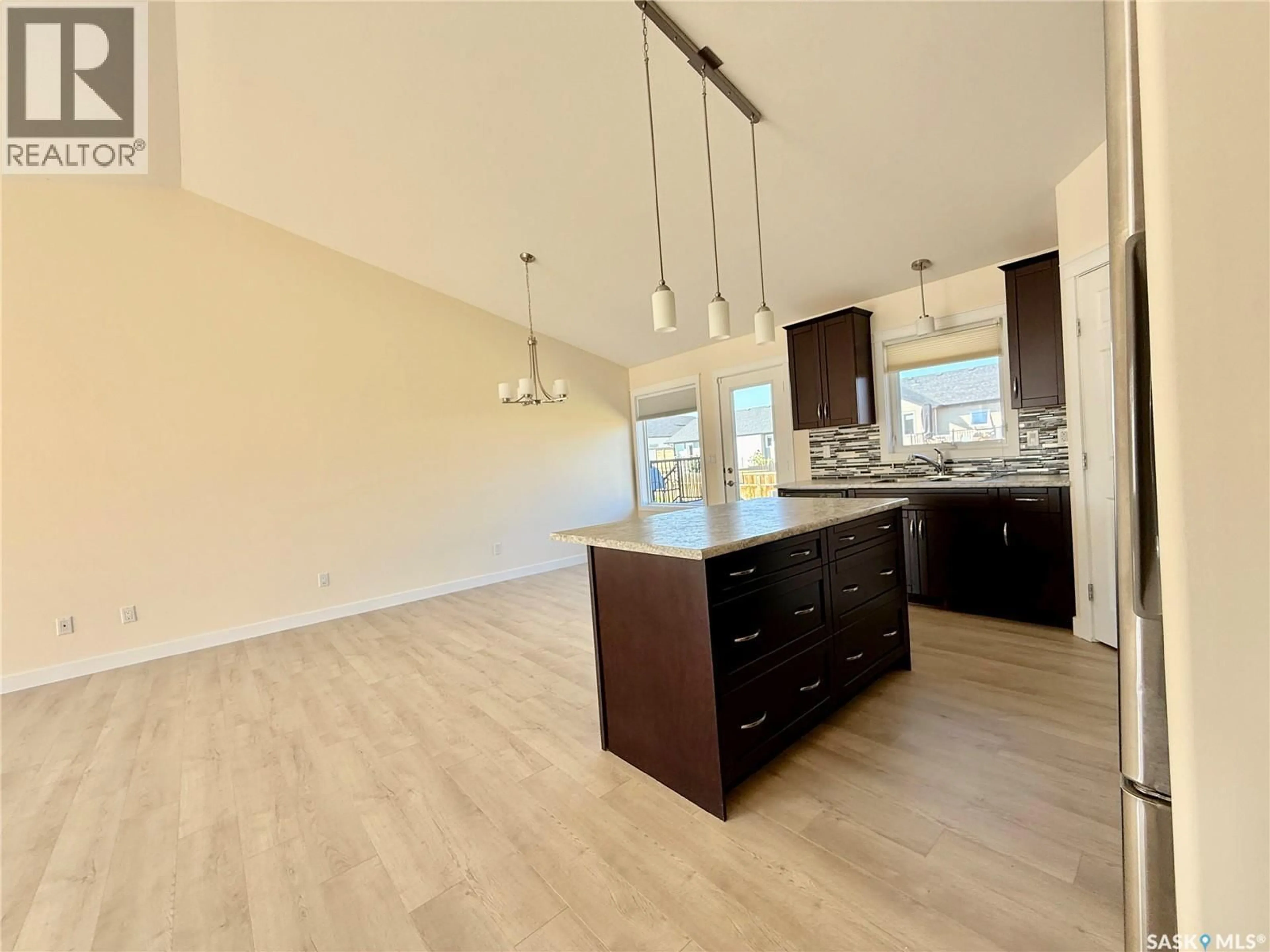 Open concept kitchen, wood/laminate floor for 726 CASPER CRESCENT, Warman Saskatchewan S0K4S4