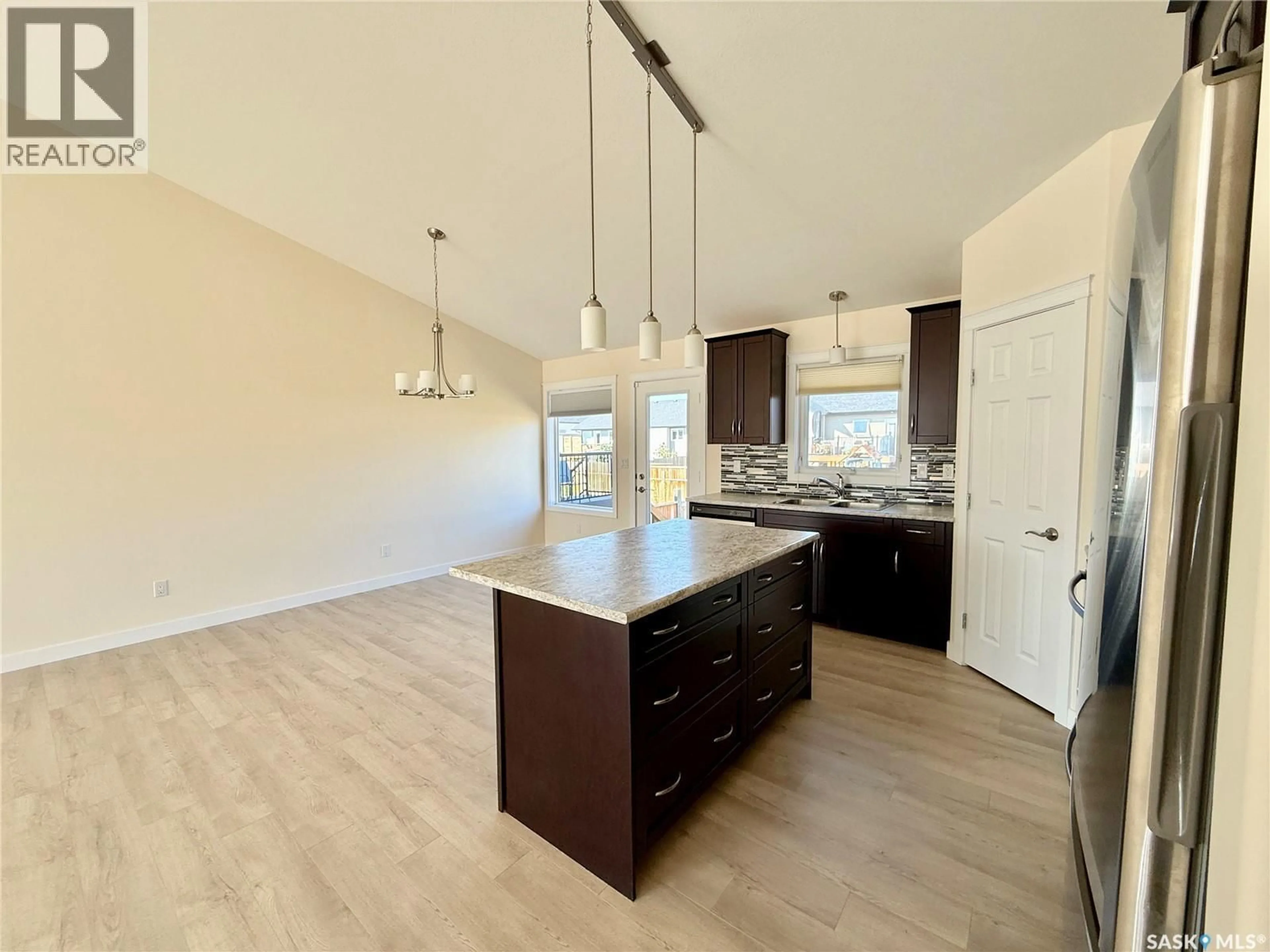 Open concept kitchen, wood/laminate floor for 726 CASPER CRESCENT, Warman Saskatchewan S0K4S4