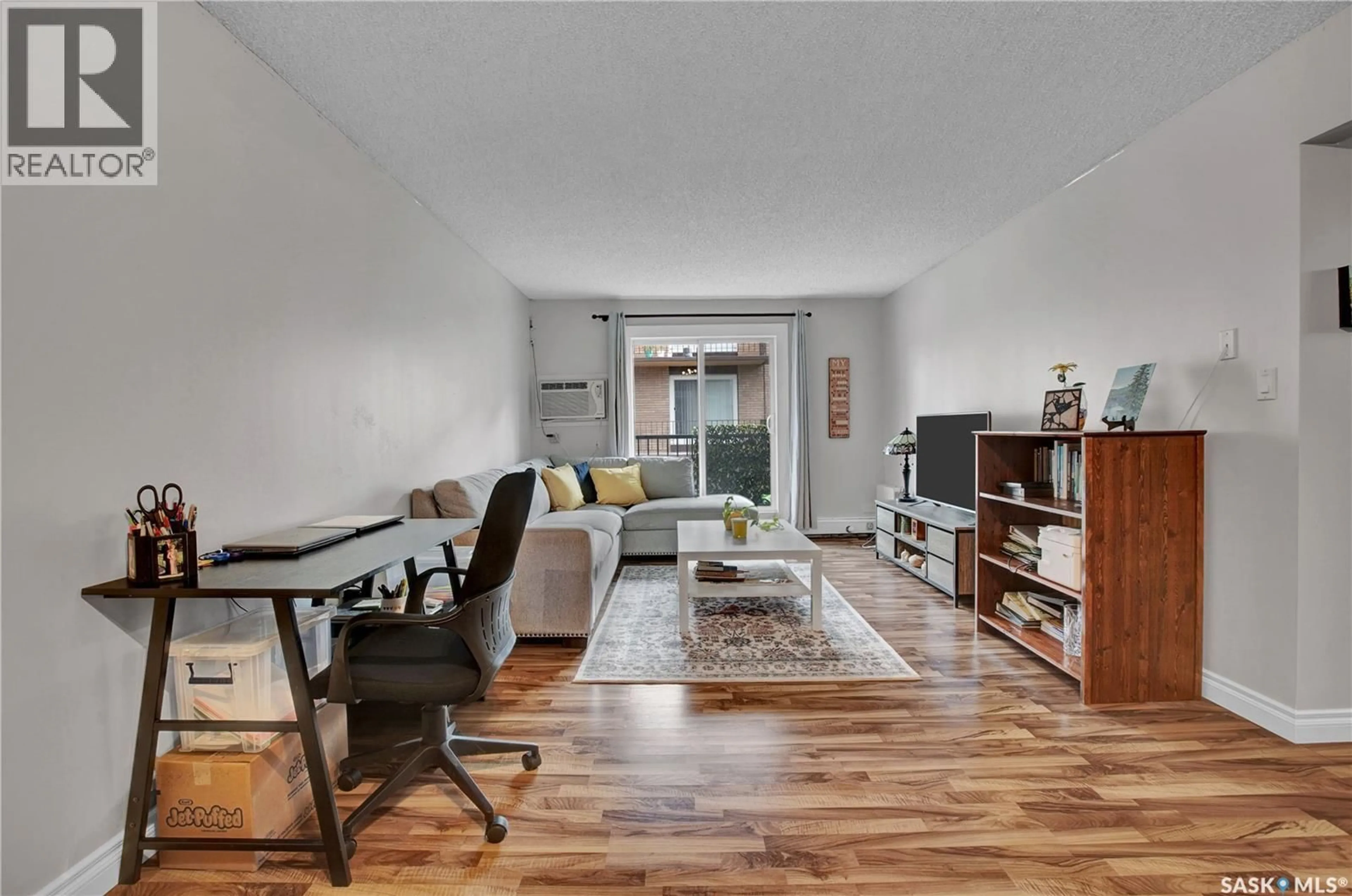 Living room with furniture, wood/laminate floor for 104 - 15 104TH STREET, Saskatoon Saskatchewan S7N1M8