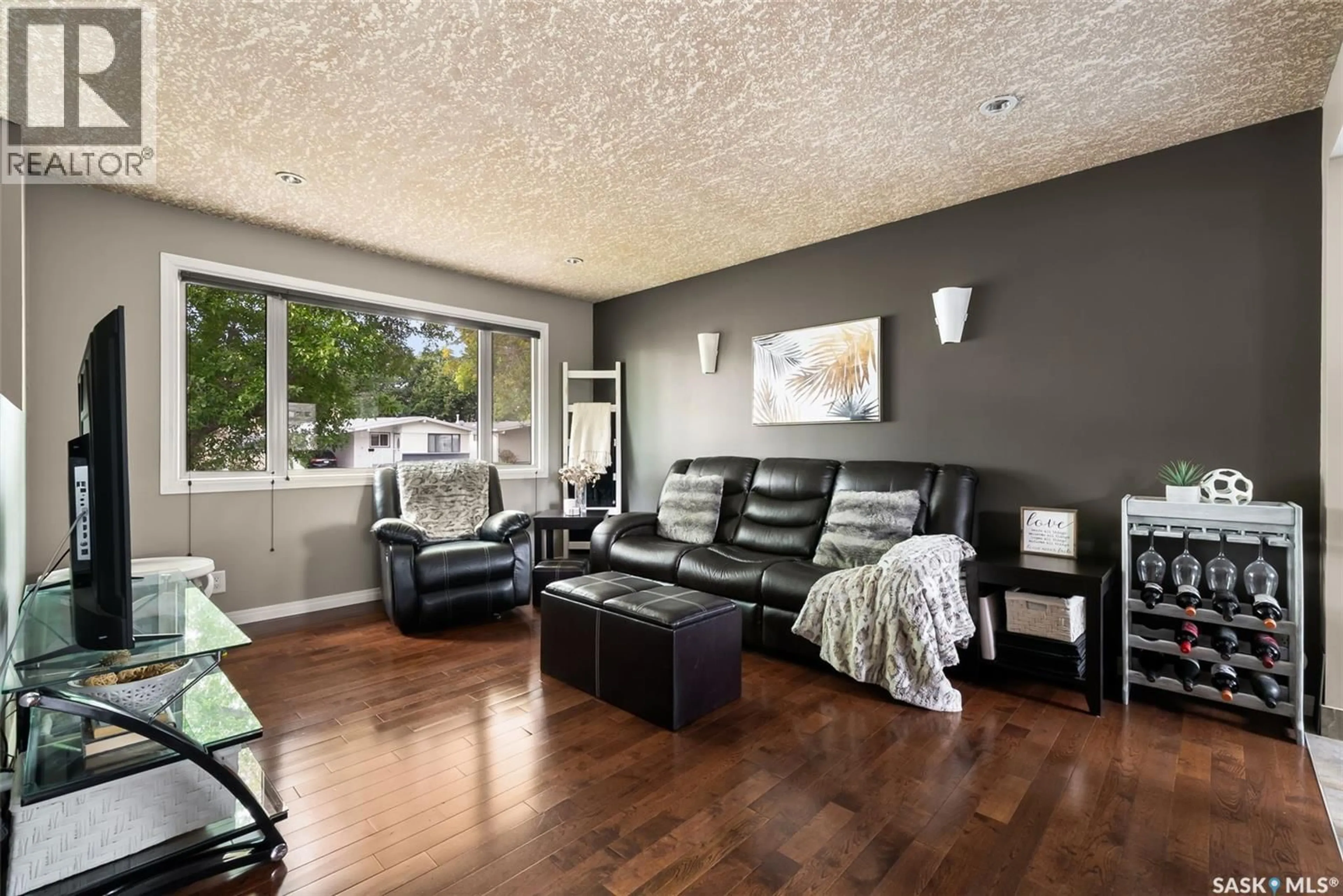 Living room with furniture, wood/laminate floor for 26 HAMMOND ROAD, Regina Saskatchewan S4R3C6