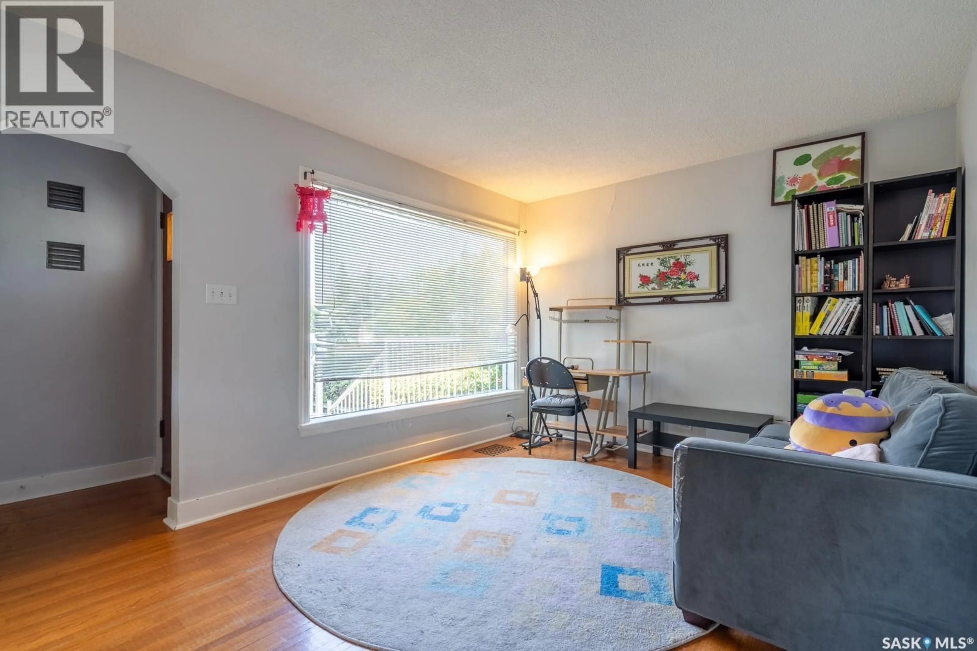 Living room with furniture, wood/laminate floor for 2113 WASCANA STREET, Regina Saskatchewan S4T4K1