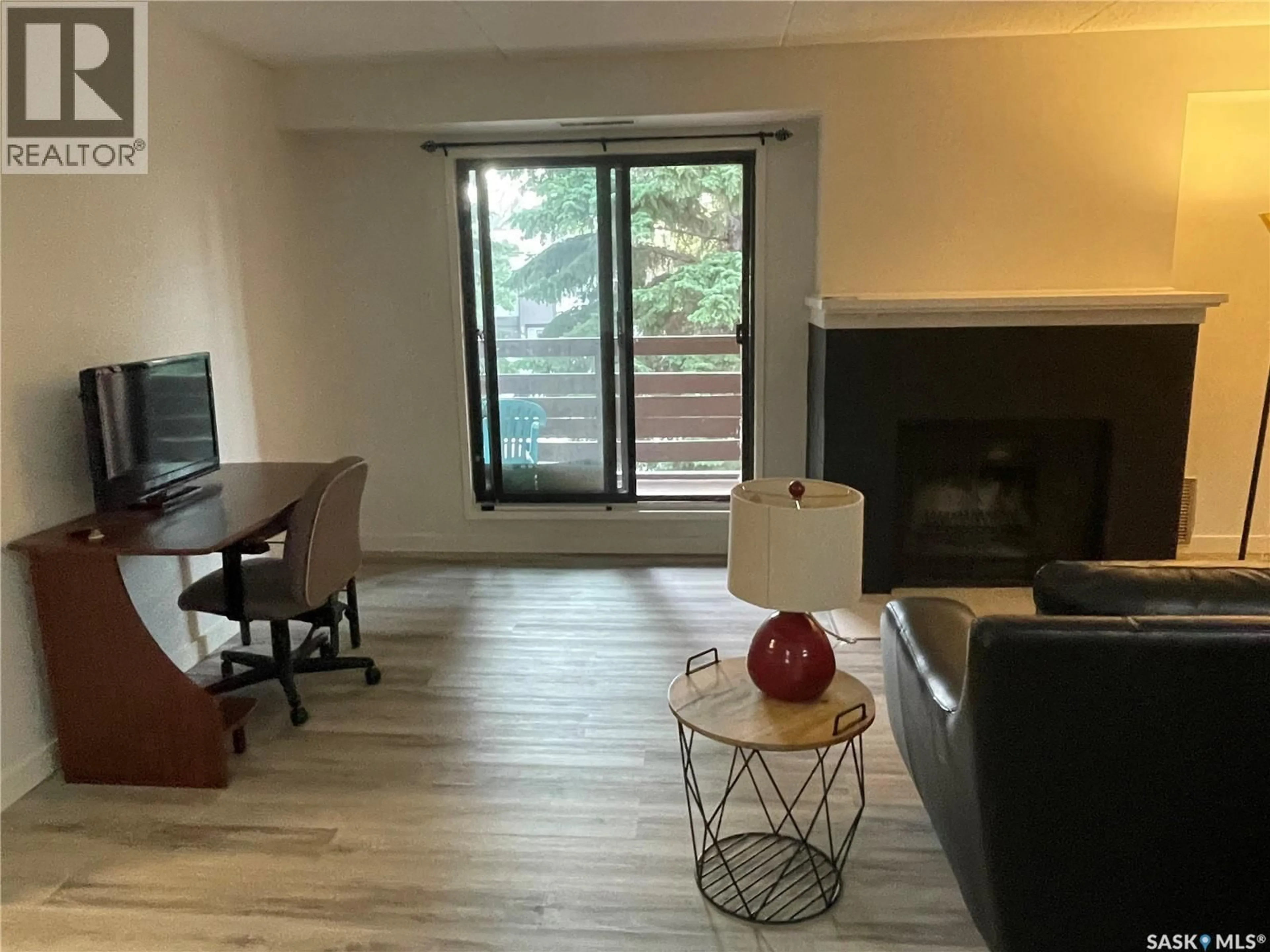 Living room with furniture, wood/laminate floor for 201 PENDYGRASSE ROAD, Saskatoon Saskatchewan S7M5C1