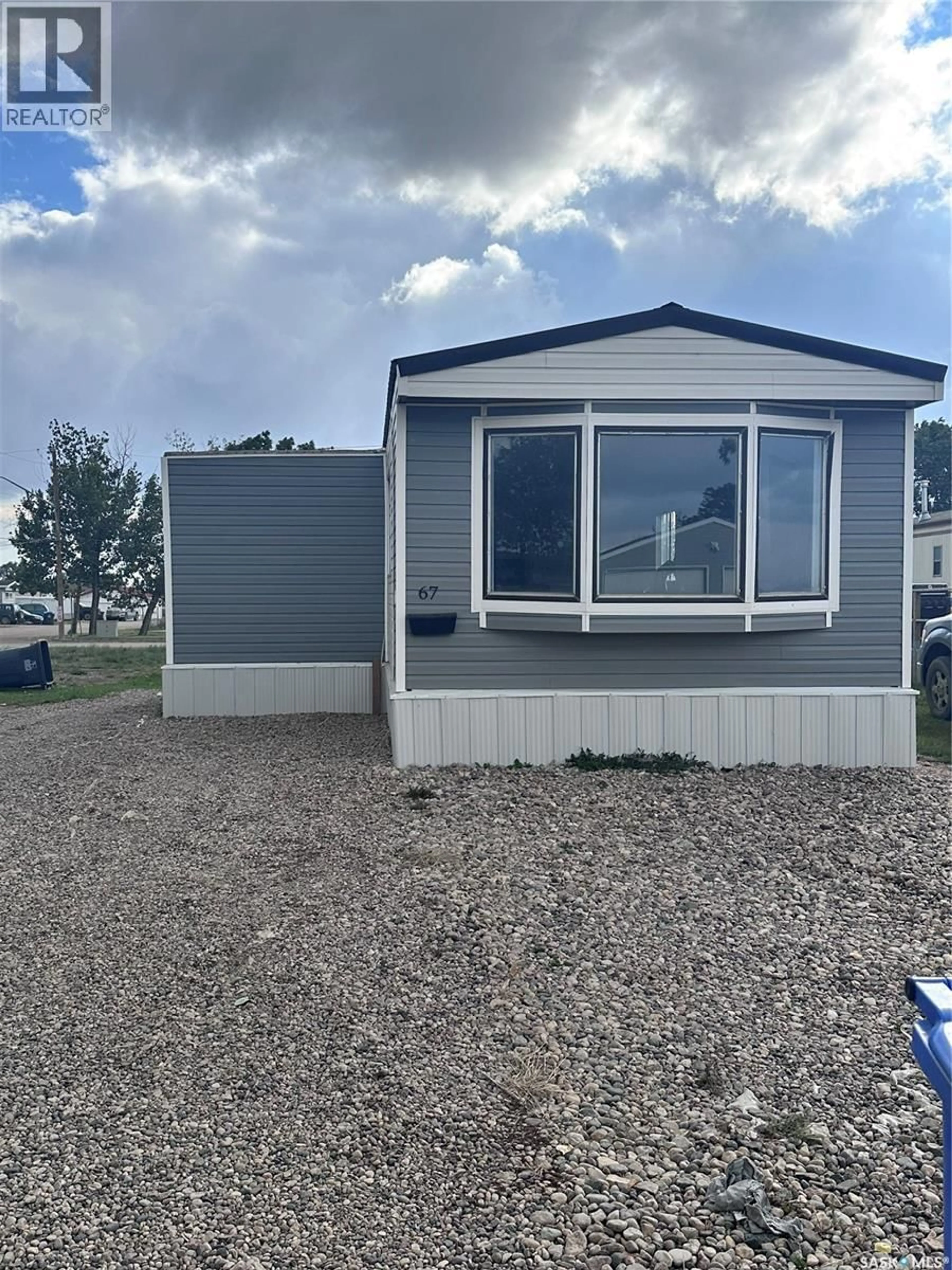 Home with vinyl exterior material, street for 106 - 67 1ST AVENUE, Weyburn Saskatchewan S4H2J1