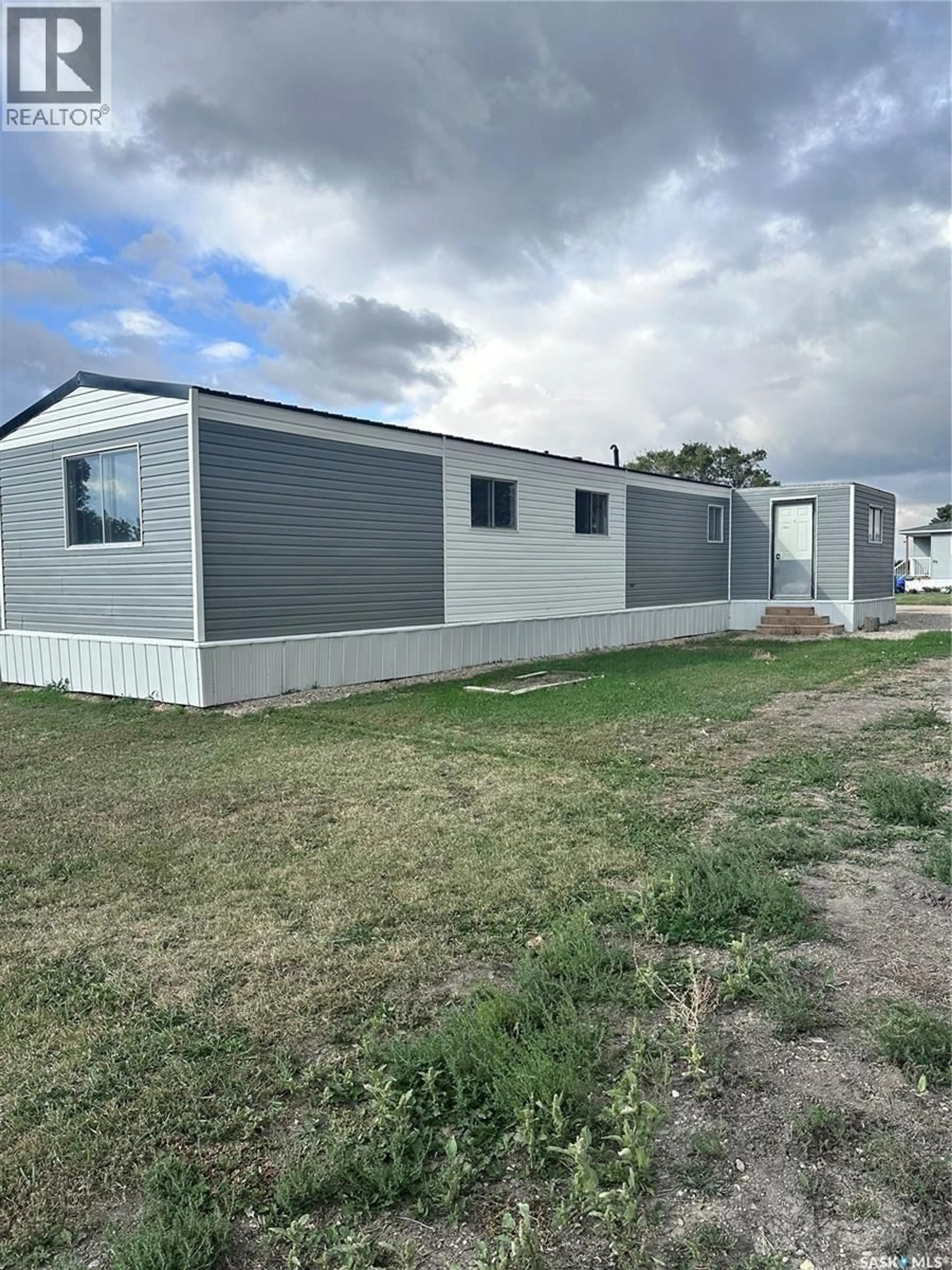 Home with vinyl exterior material, street for 106 - 67 1ST AVENUE, Weyburn Saskatchewan S4H2J1