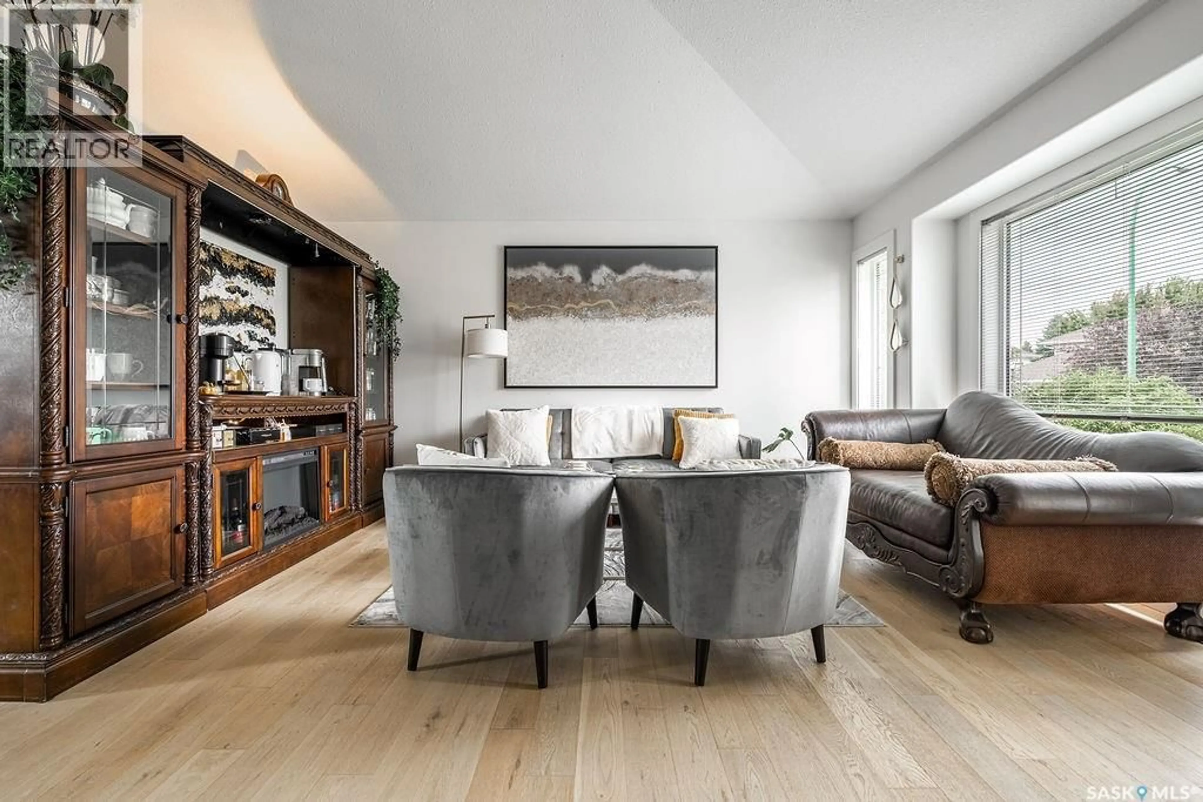 Living room with furniture, wood/laminate floor for 231 BROOKMORE LANE, Saskatoon Saskatchewan S7V1C2