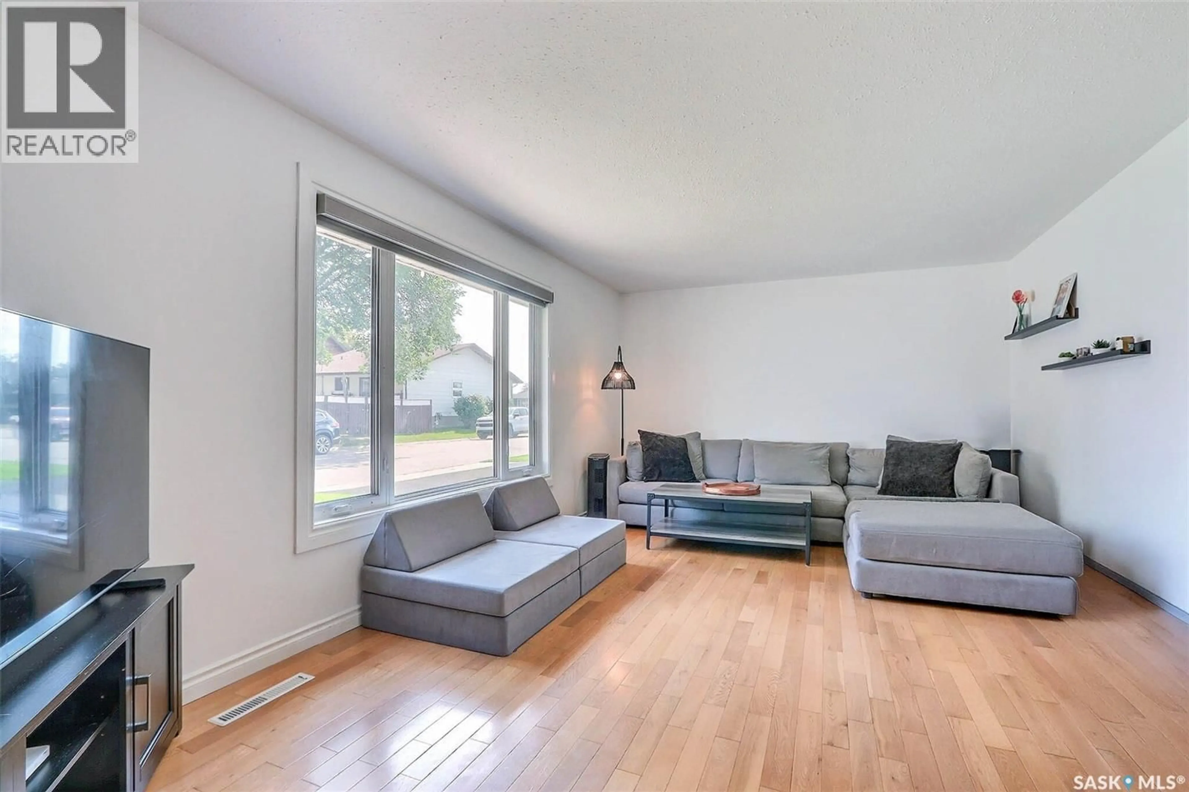 Living room with furniture, wood/laminate floor for 2115 5A AVENUE W, Prince Albert Saskatchewan S6V5J5