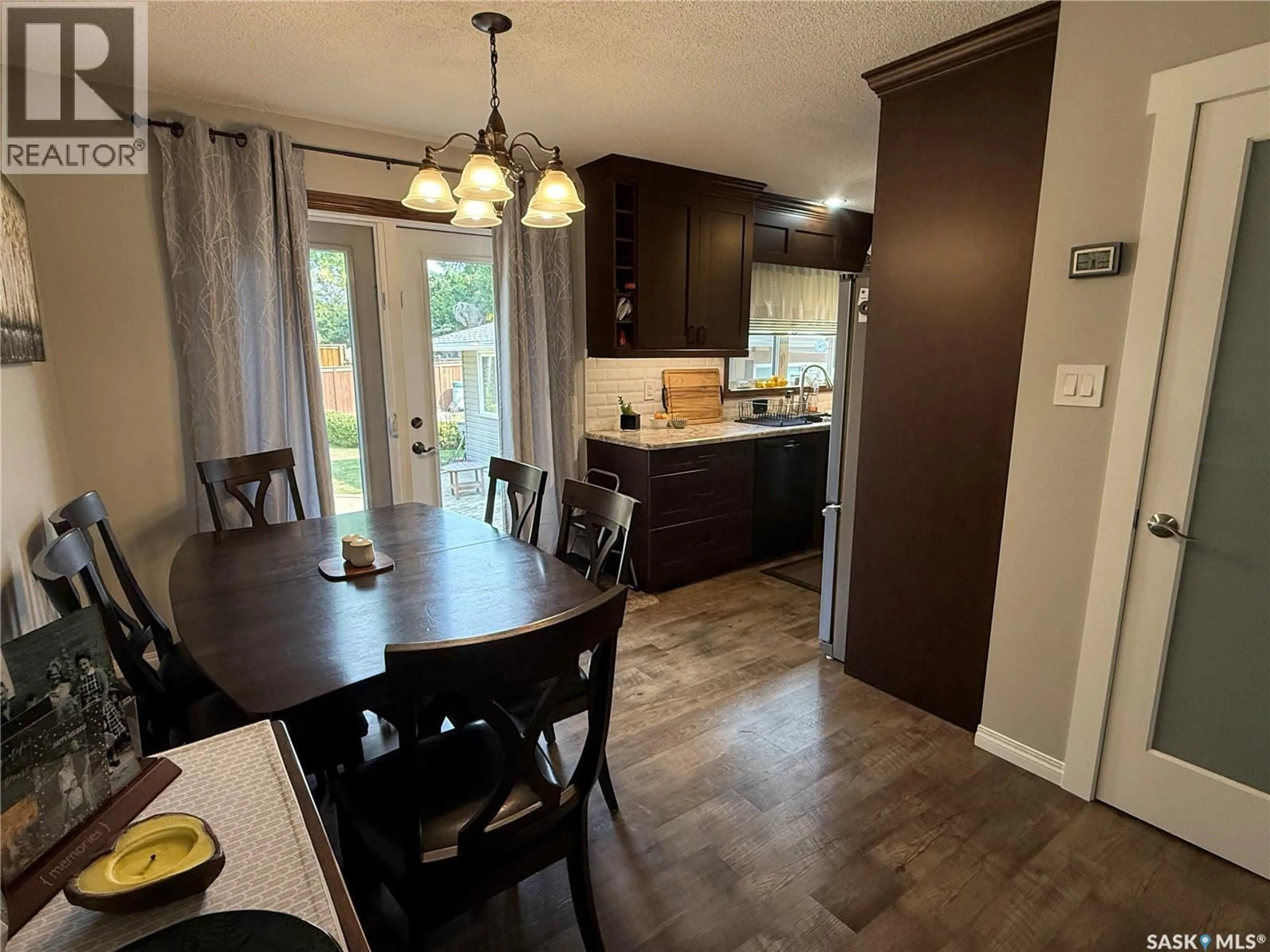 Open concept kitchen, wood/laminate floor for 15 MITCHELL CRESCENT, Weyburn Saskatchewan S4H2M3