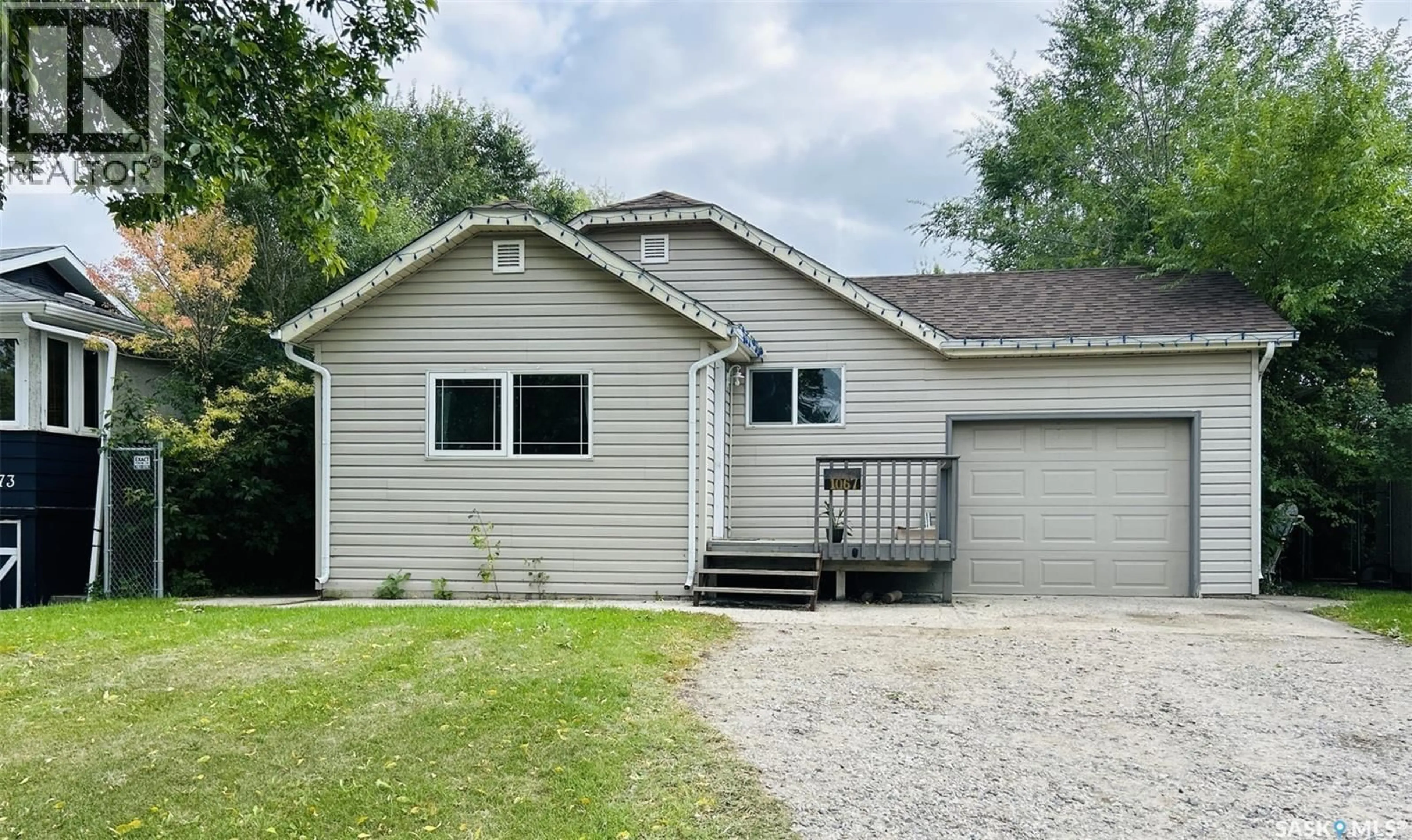 Home with vinyl exterior material, street for 1067 1ST STREET, Prince Albert Saskatchewan S6V0C2