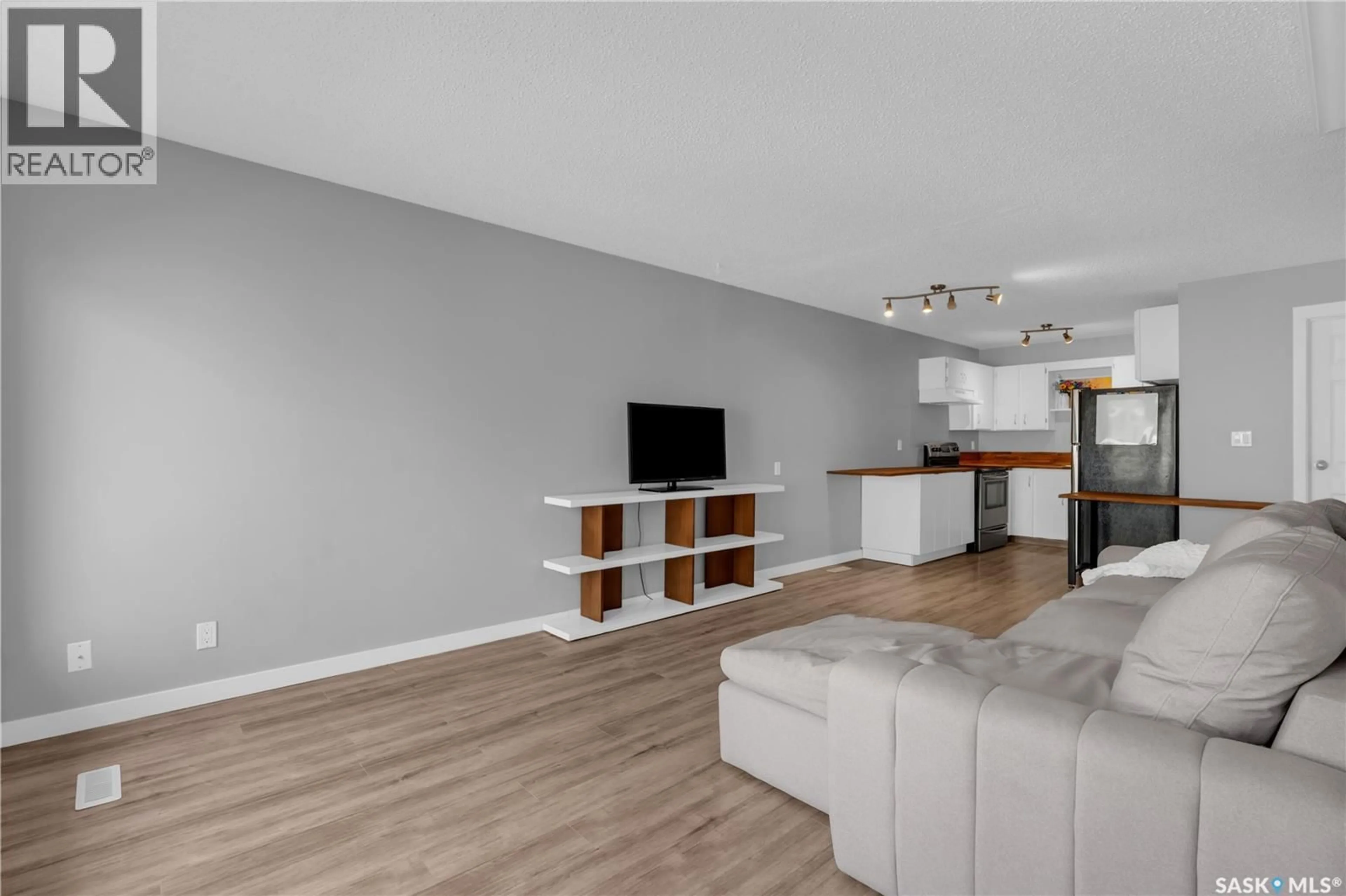 Living room with furniture, wood/laminate floor for 7320 DALGLIESH DRIVE, Regina Saskatchewan S4X2K8