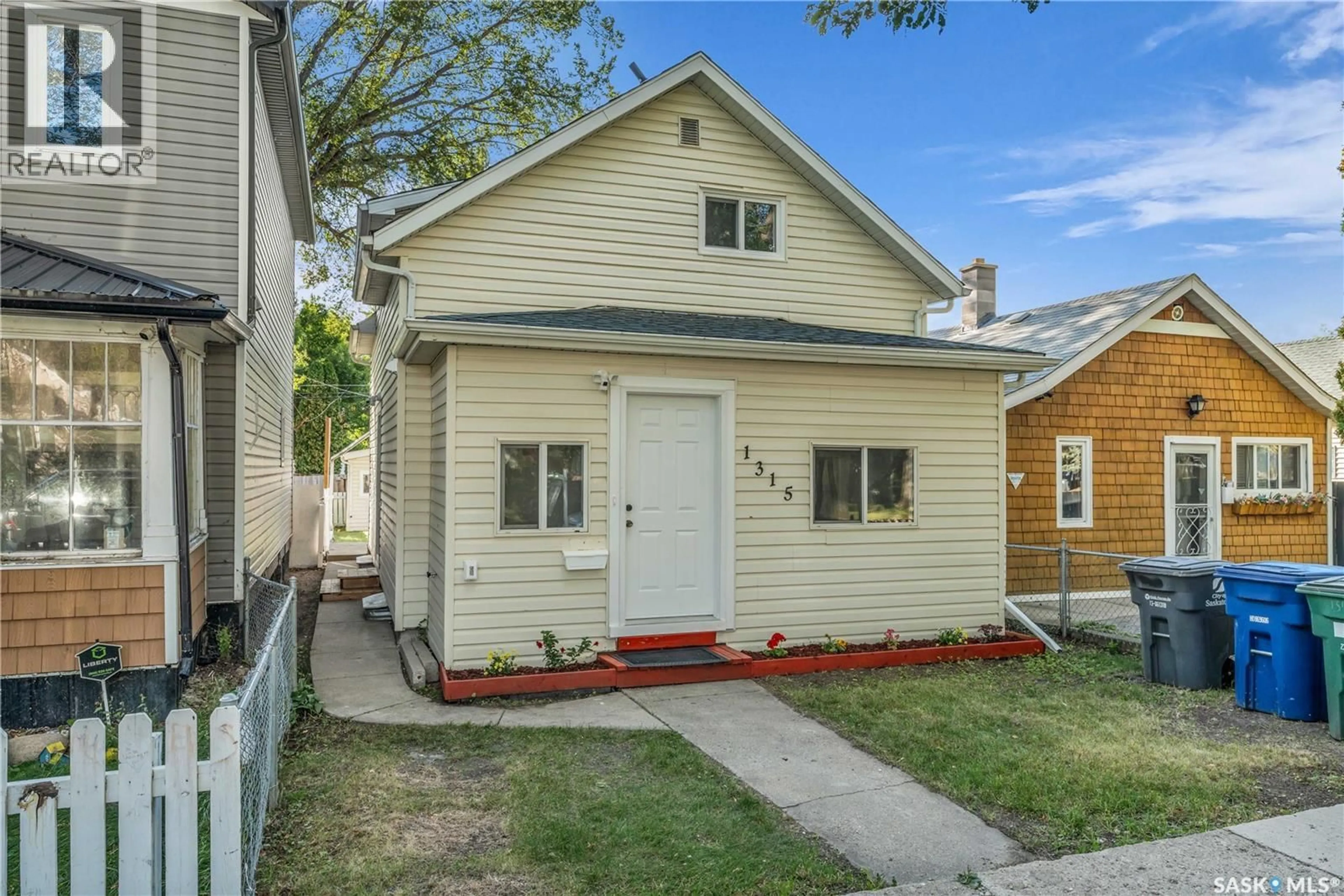 Home with vinyl exterior material, street for 1315 G AVENUE, Saskatoon Saskatchewan S7M2N4