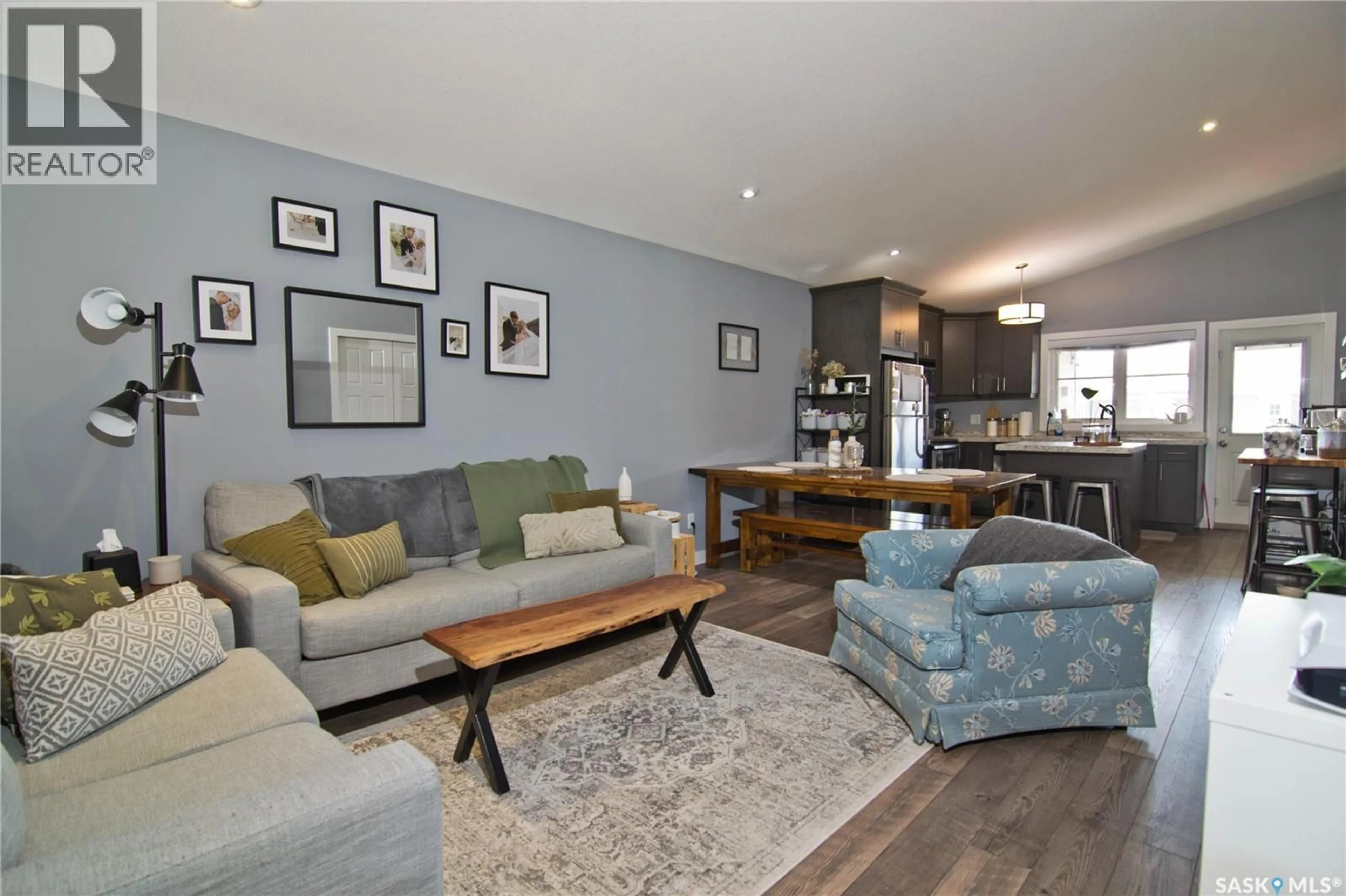 Living room with furniture, wood/laminate floor for E - 4140 GREEN APPLE DRIVE, Regina Saskatchewan S4V1S1