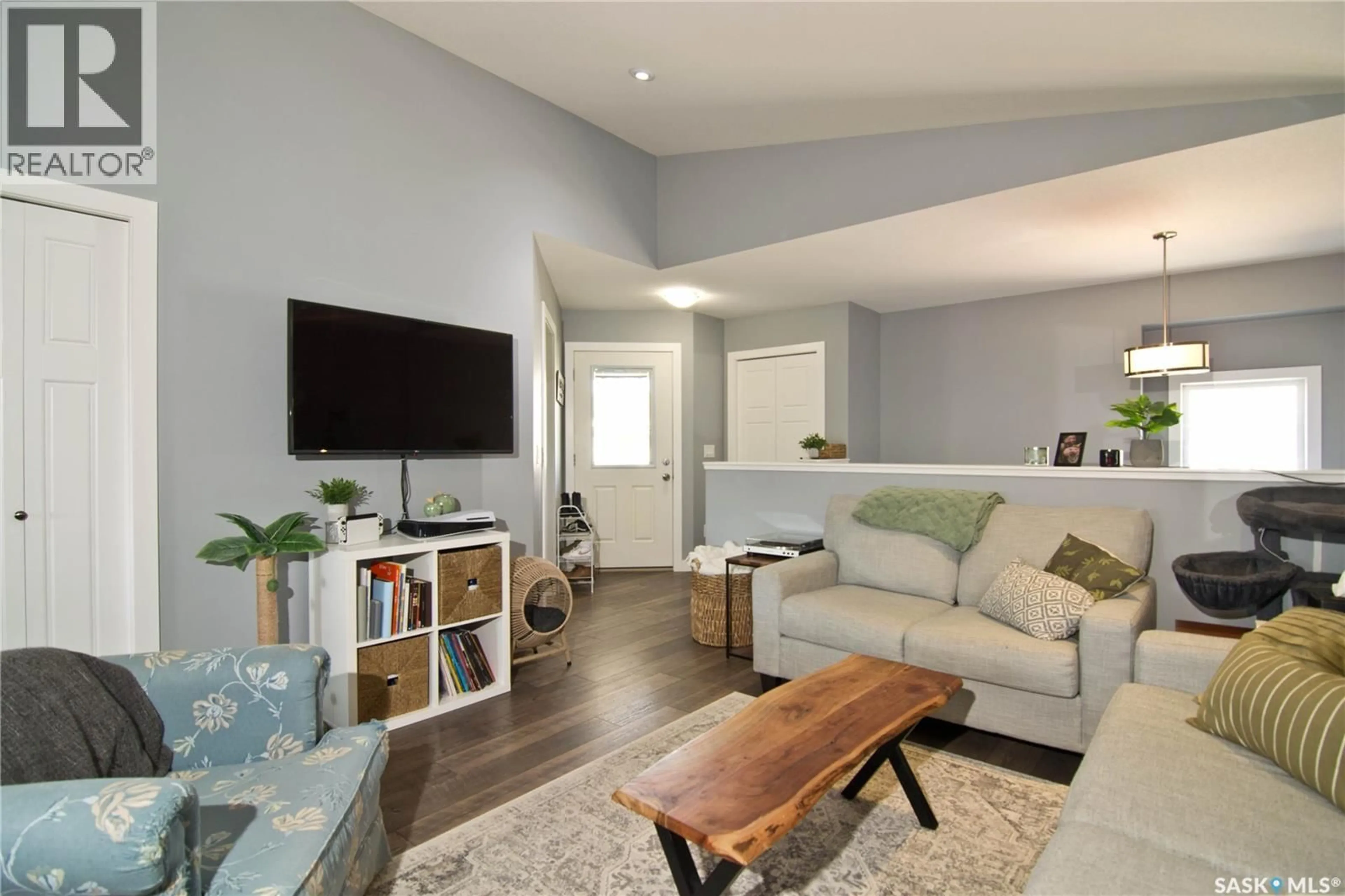 Living room with furniture, wood/laminate floor for E - 4140 GREEN APPLE DRIVE, Regina Saskatchewan S4V1S1