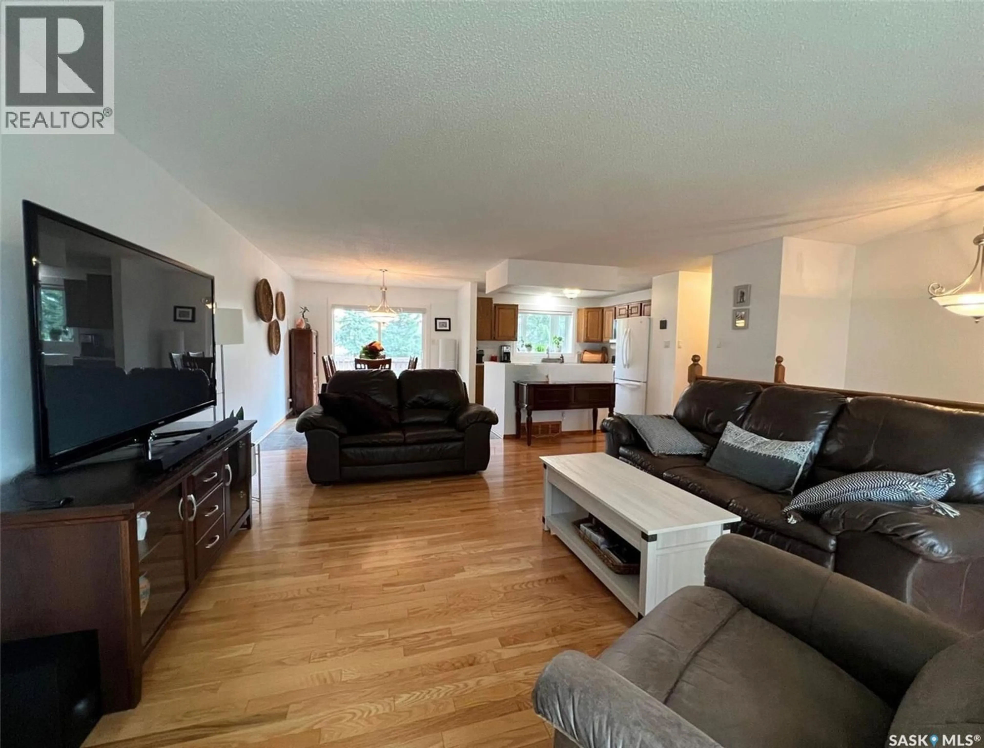 Living room with furniture, wood/laminate floor for 365 BUFFALO PLACE, Swift Current Saskatchewan S9H4X2