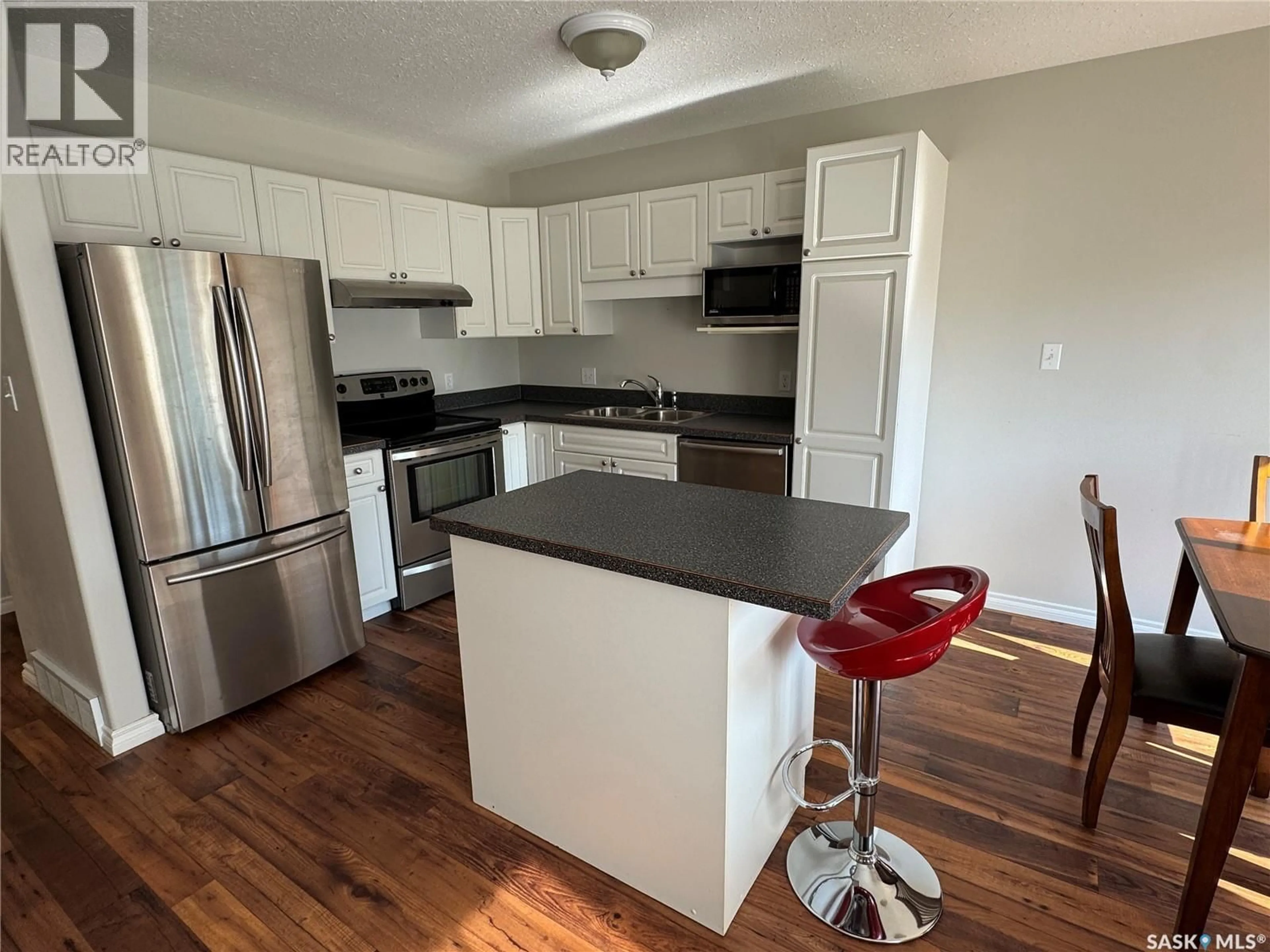 Open concept kitchen, wood/laminate floor for 10 1327 STUDER STREET, La Ronge Saskatchewan S0J1L0