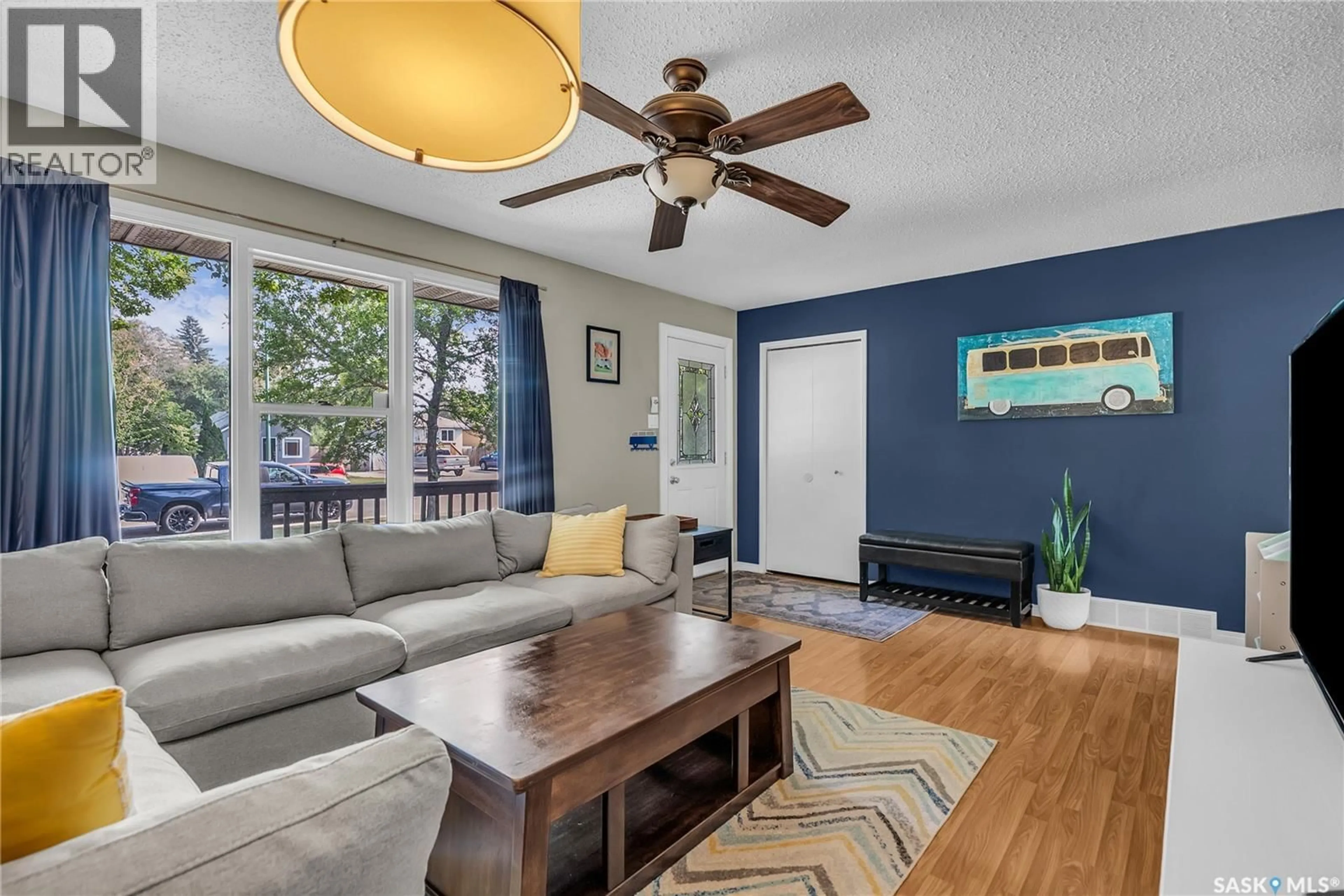 Living room with furniture, wood/laminate floor for 2414 MCPHERSON AVENUE, Saskatoon Saskatchewan S7J0S9