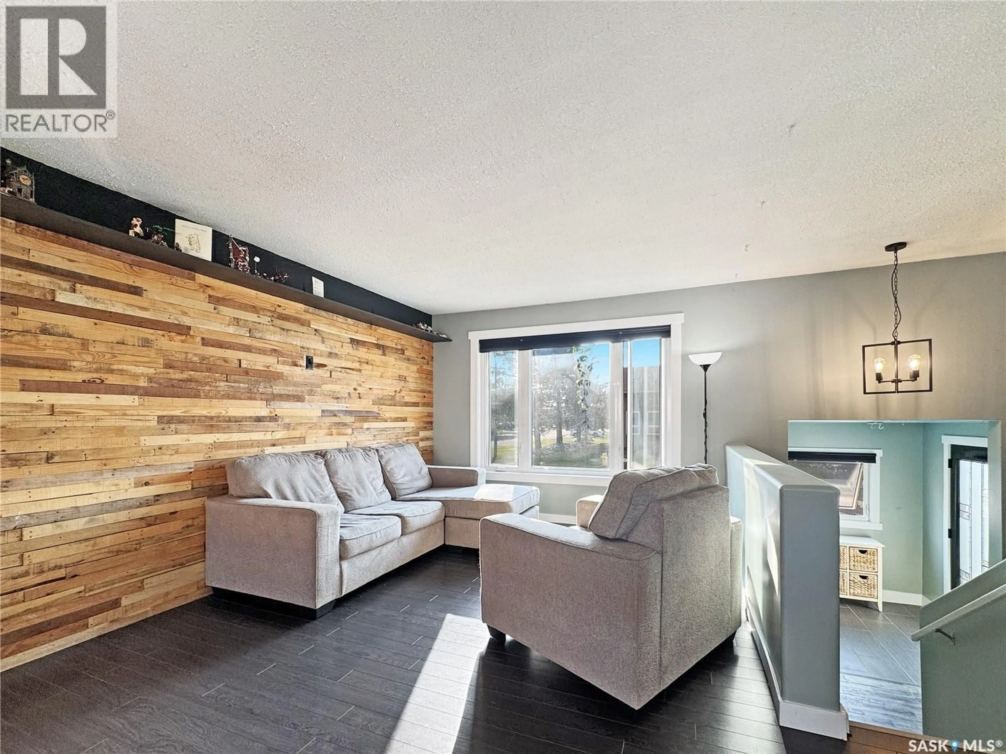 Living room with furniture, wood/laminate floor for 11345 CLARK DRIVE, North Battleford Saskatchewan S9A3P6