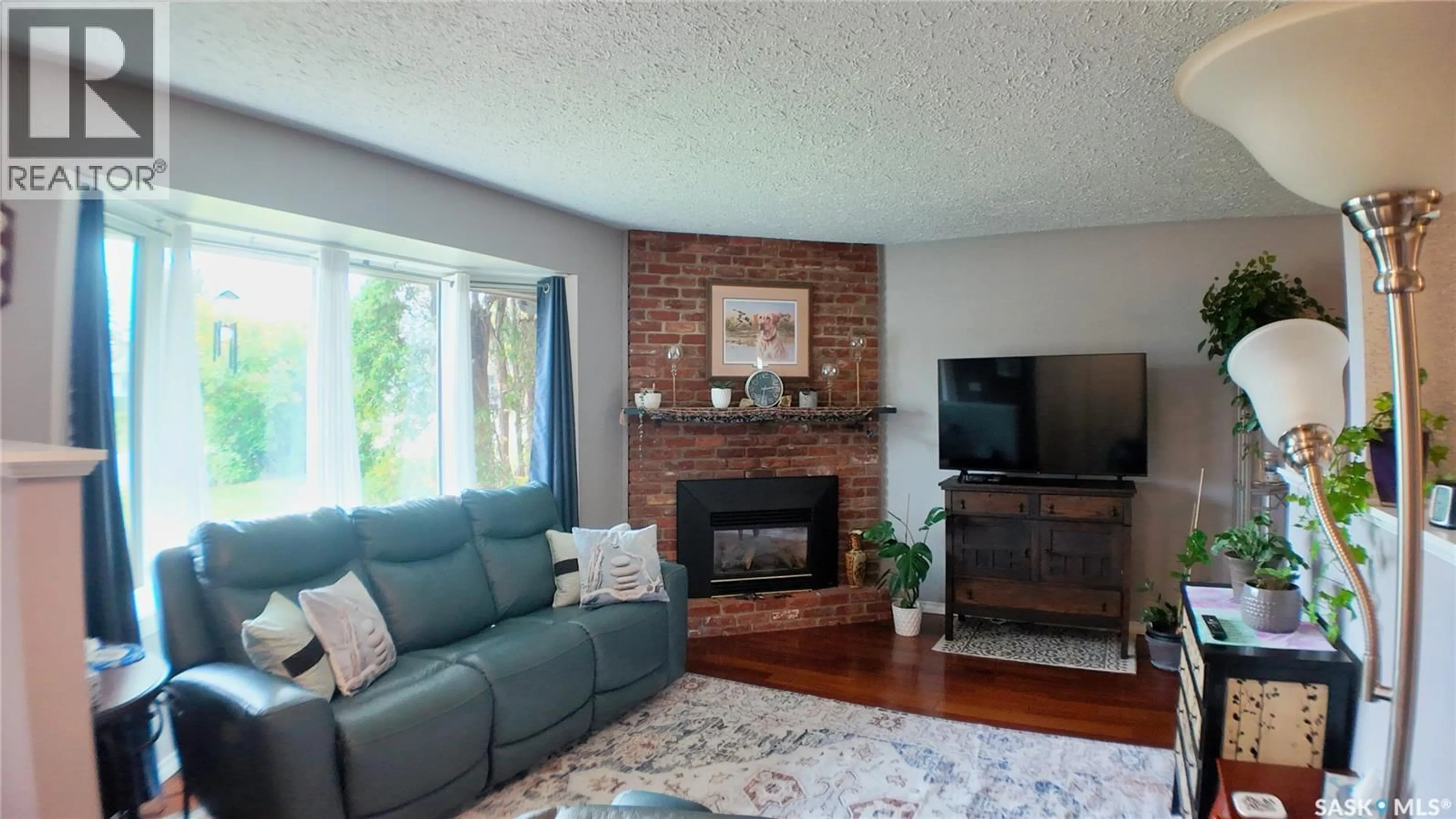 Living room with furniture, wood/laminate floor for 362 35TH STREET, Battleford Saskatchewan S0M0E0