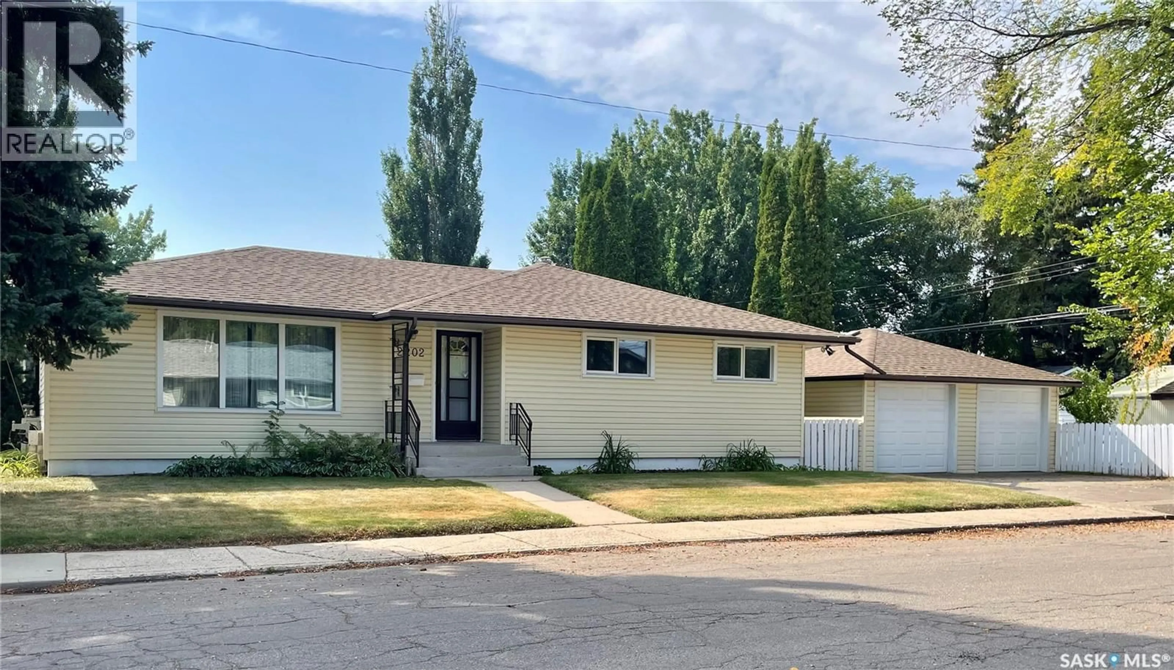 Home with vinyl exterior material, street for 2202 EWART AVENUE, Saskatoon Saskatchewan S7J1Y2