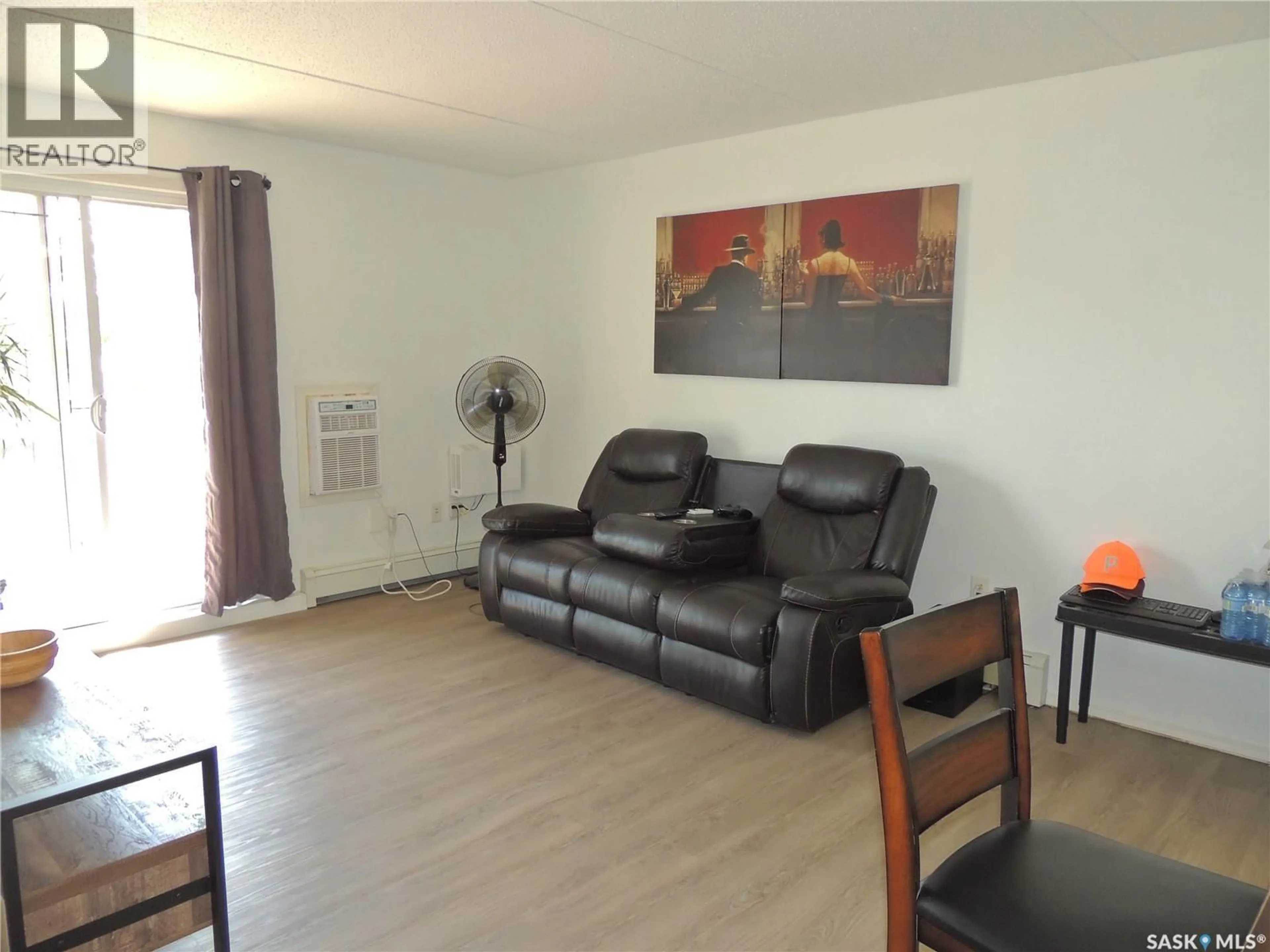 Living room with furniture, wood/laminate floor for 701 - 201 HENRY STREET, Estevan Saskatchewan S4A2B7