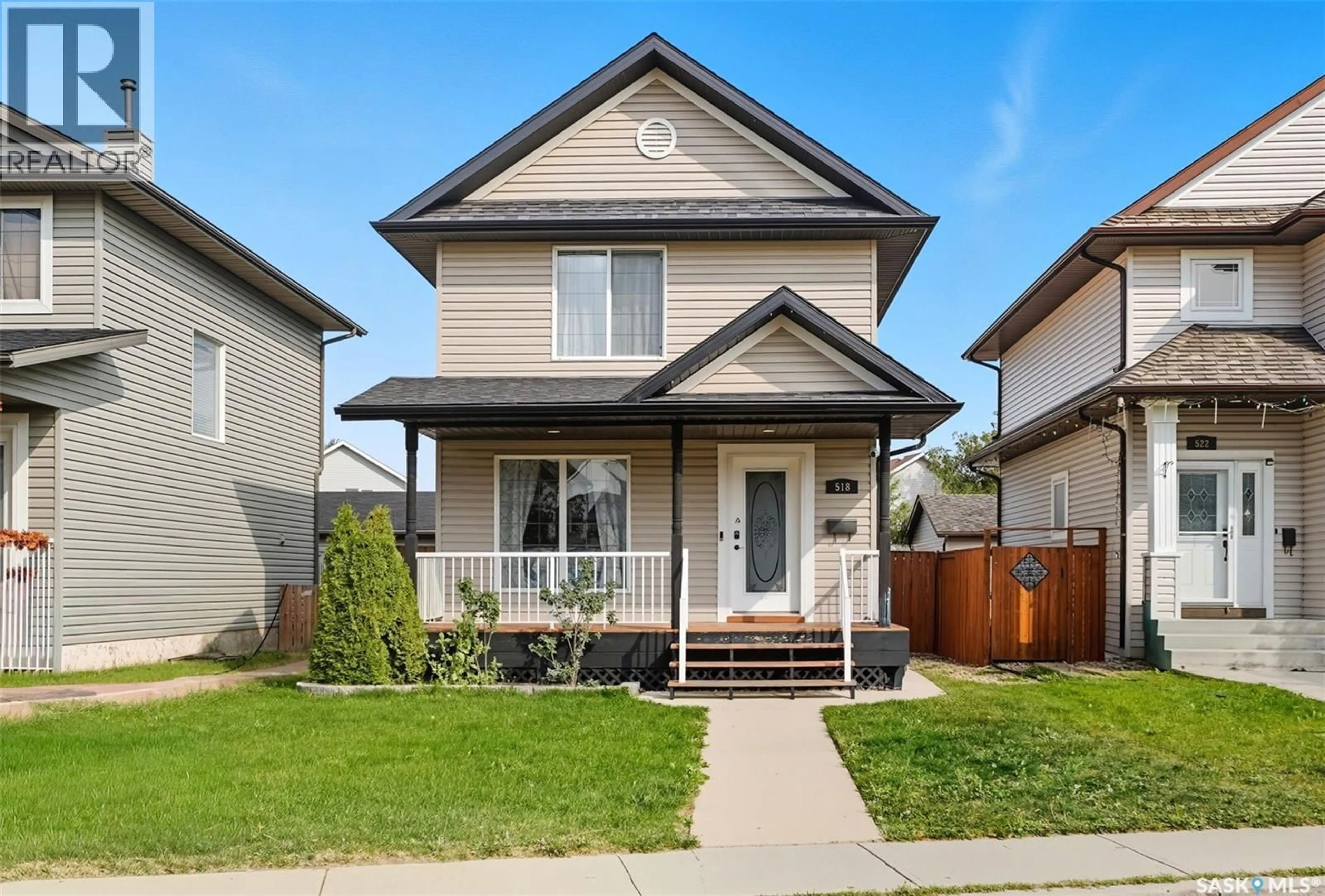 Home with vinyl exterior material, street for 518 DENHAM WAY, Saskatoon Saskatchewan S7R1E7