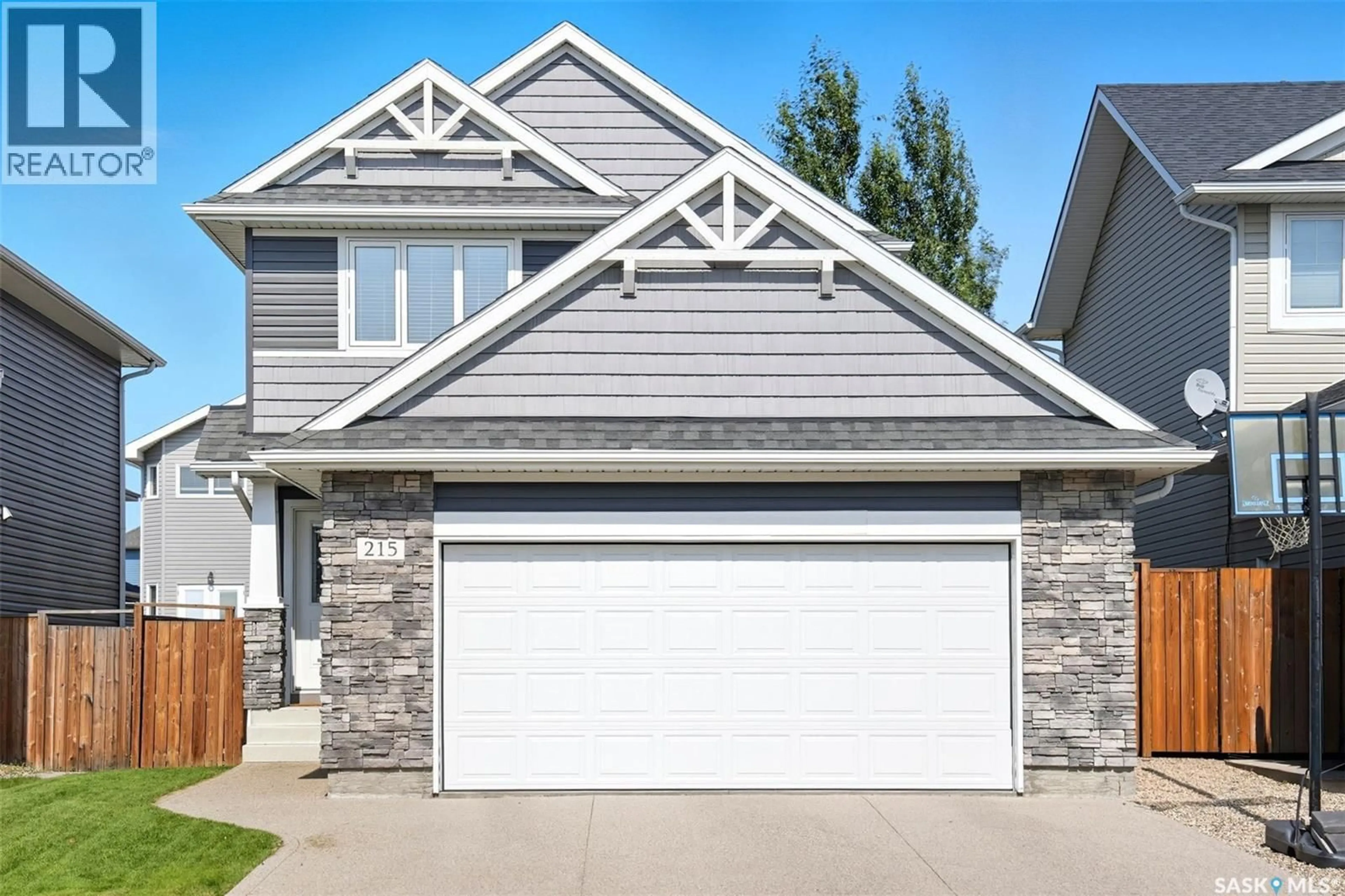 Home with vinyl exterior material, street for 215 KOLYNCHUK MANOR, Saskatoon Saskatchewan S7T0W4