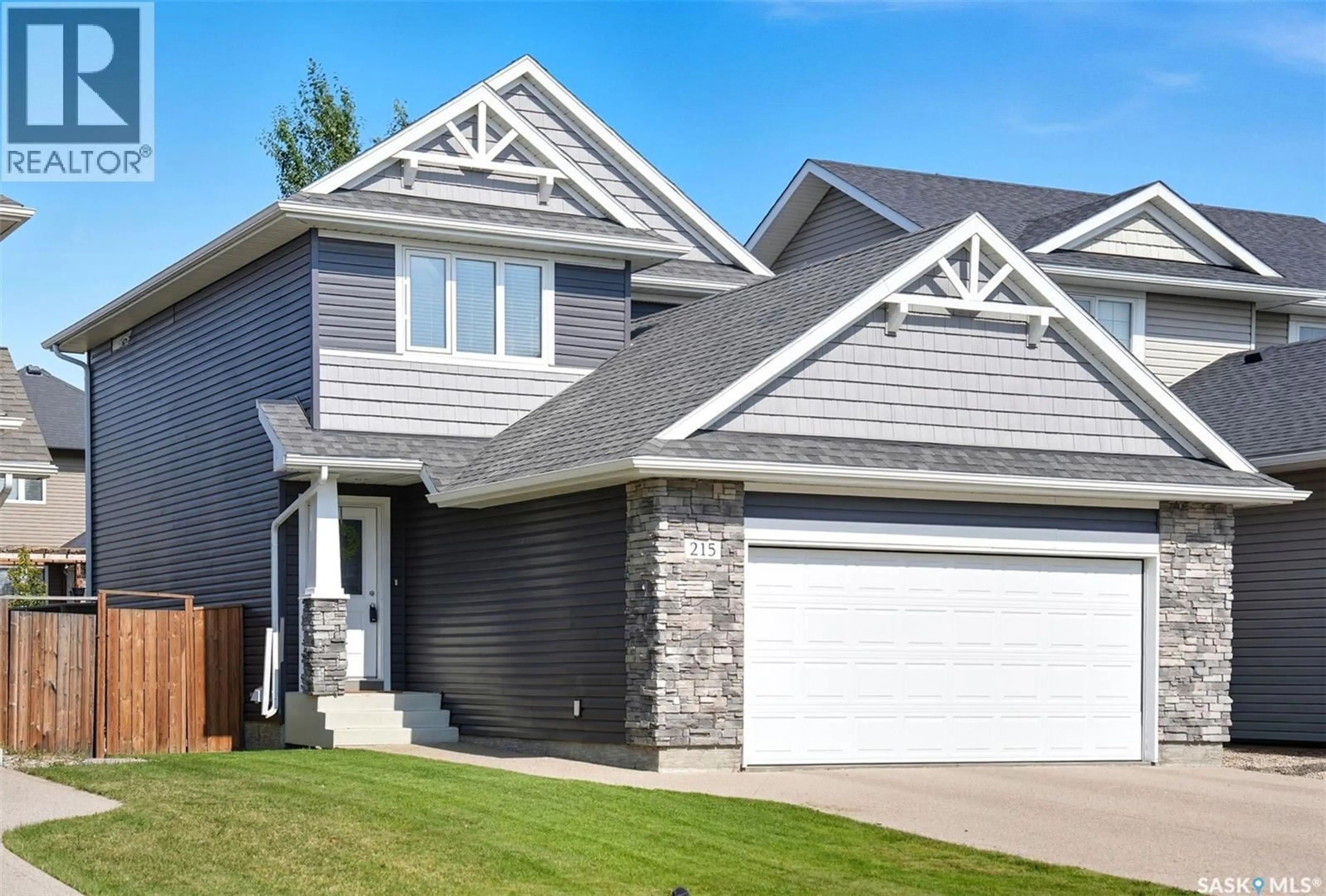 Home with vinyl exterior material, street for 215 KOLYNCHUK MANOR, Saskatoon Saskatchewan S7T0W4